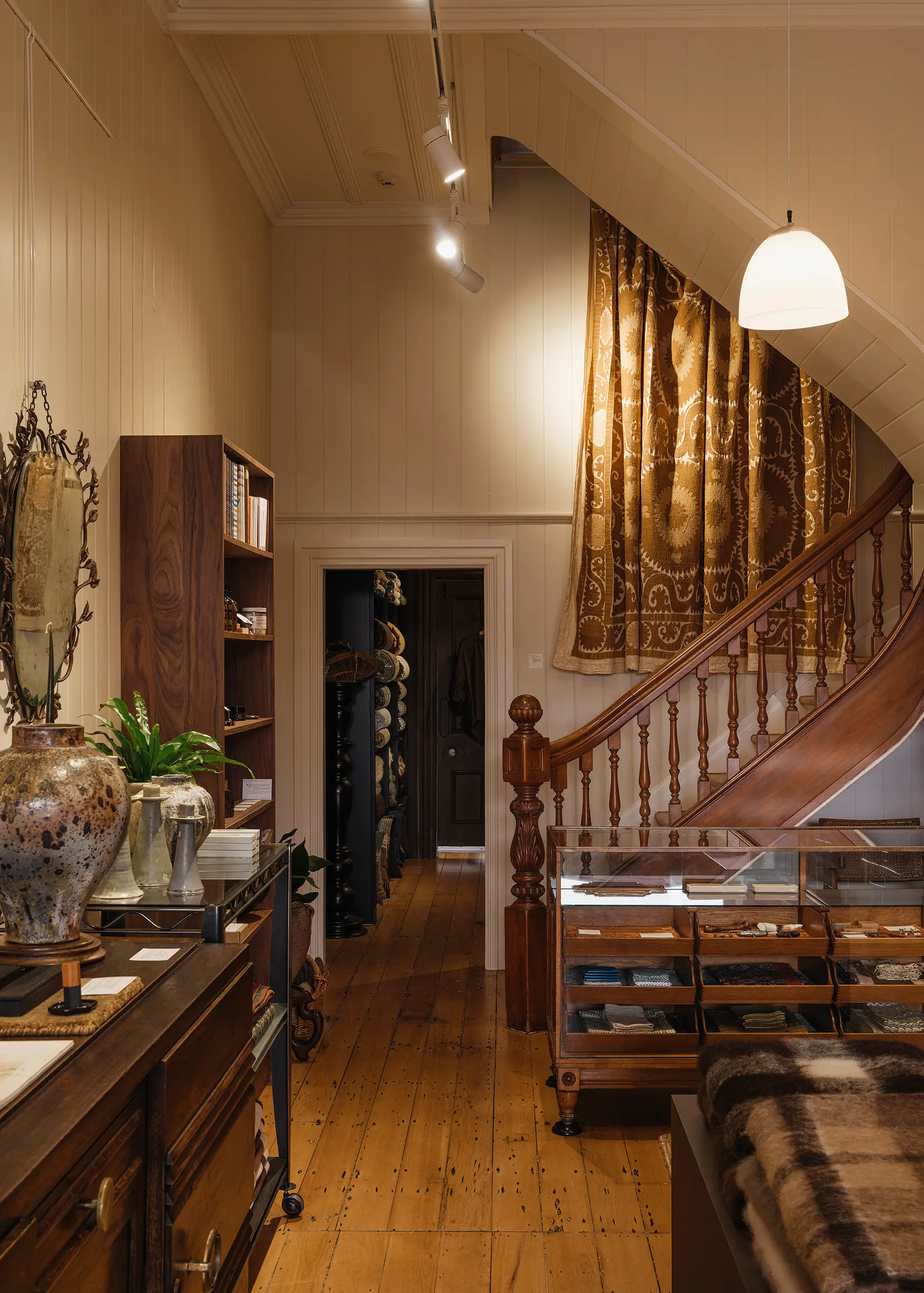 Wide view of Handcrafted Modern's heritage interior in Ponsonby, Auckland, showing the original timber staircase, contemporary craft displays and the transition from the Deuce gallery to the Forest Floor textile room.