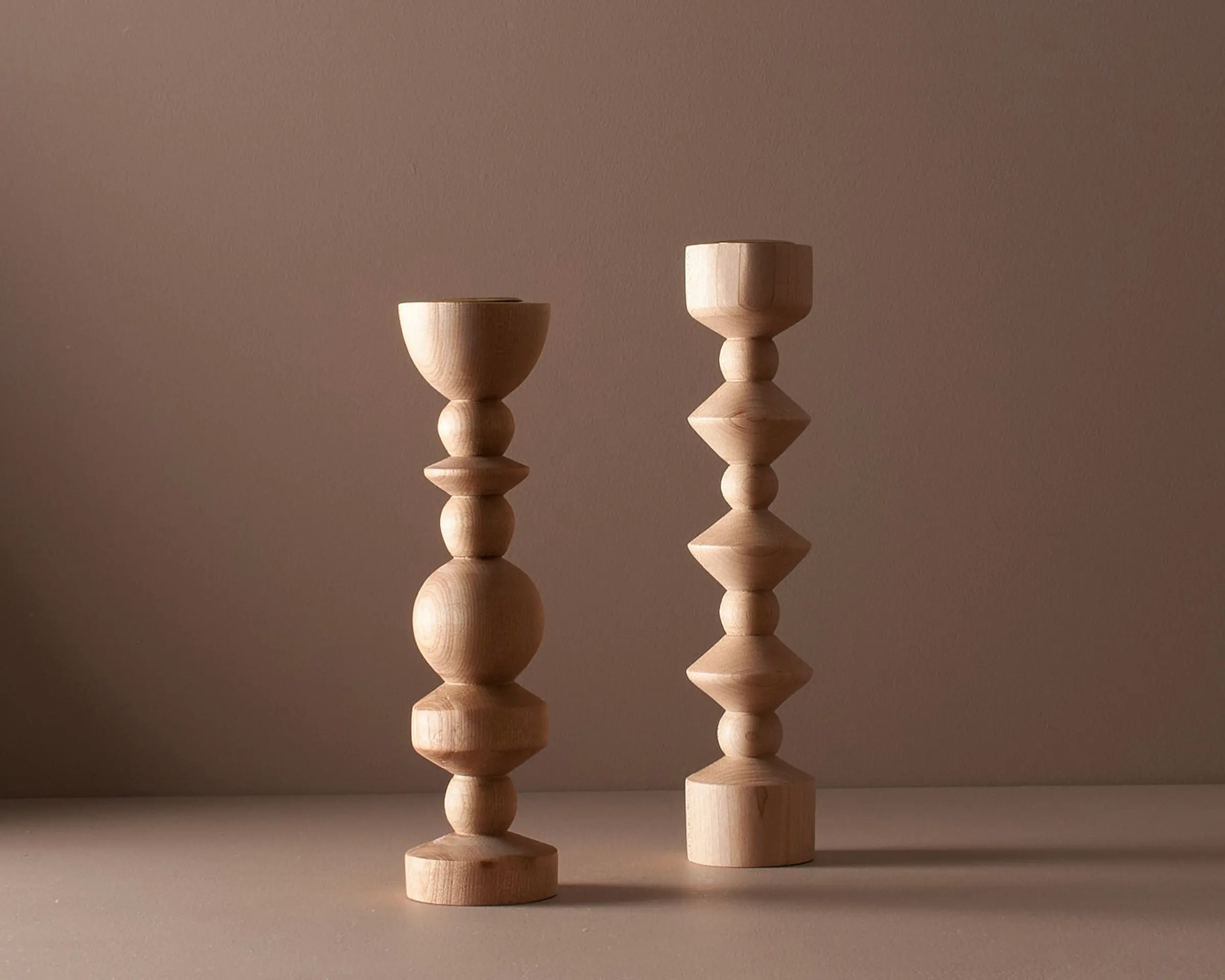 Elise mclauchlan wooden tapered medium and tall candle holders on a moody brown background