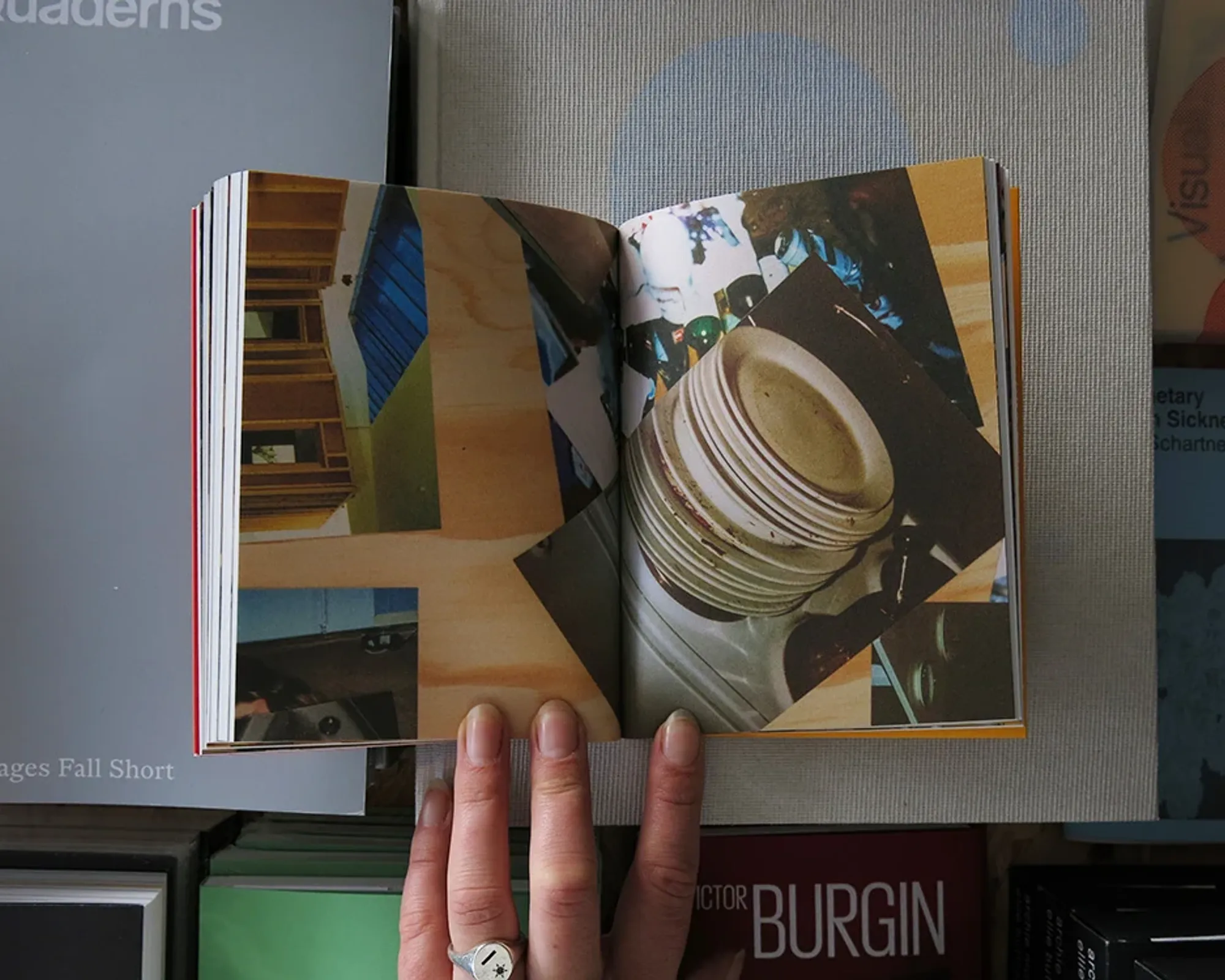 On Making Less by Rirkrit Tiravanija open to a photographic spread featuring stacked ceramic plates and an interior workspace.
