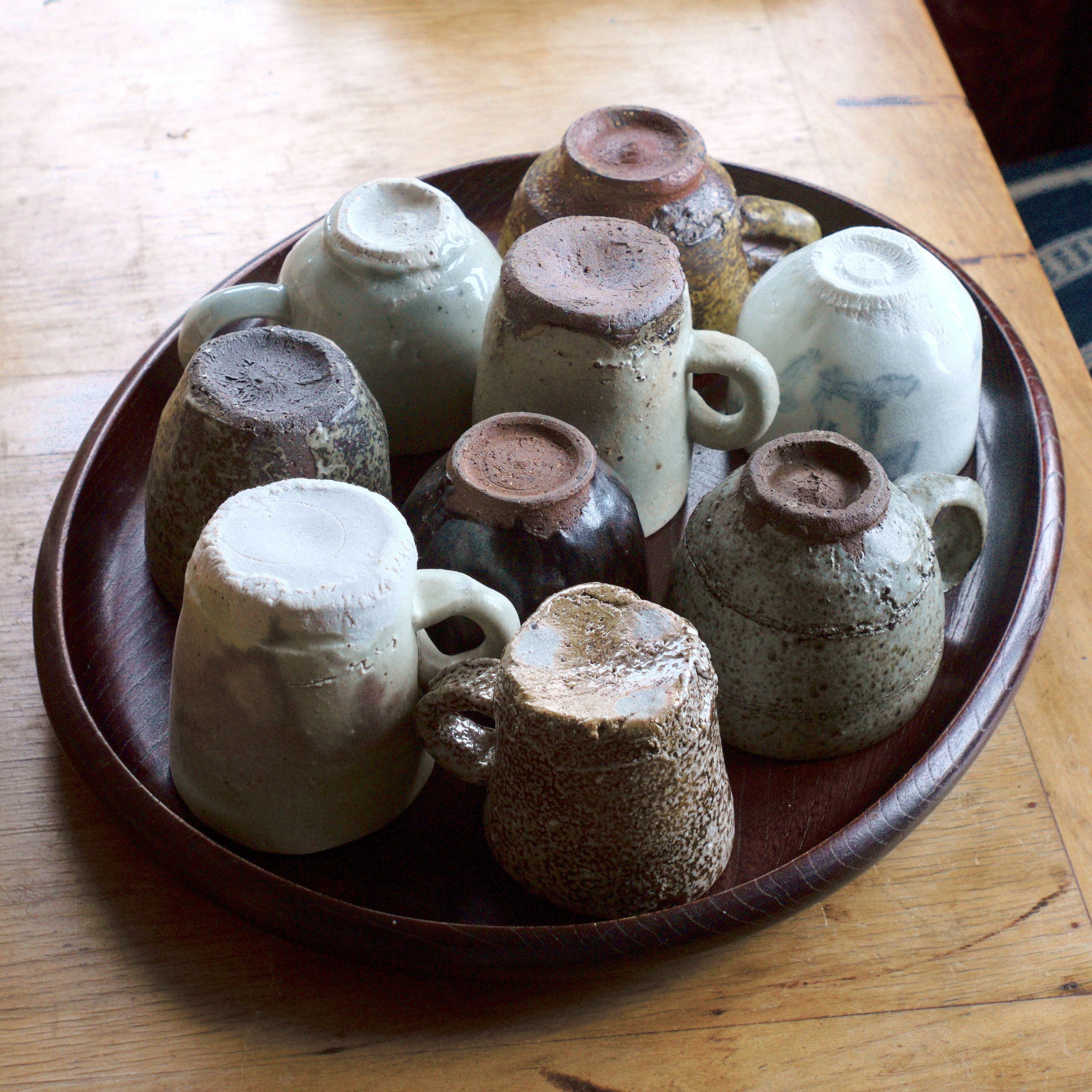 A collection of pottery cups on a tray