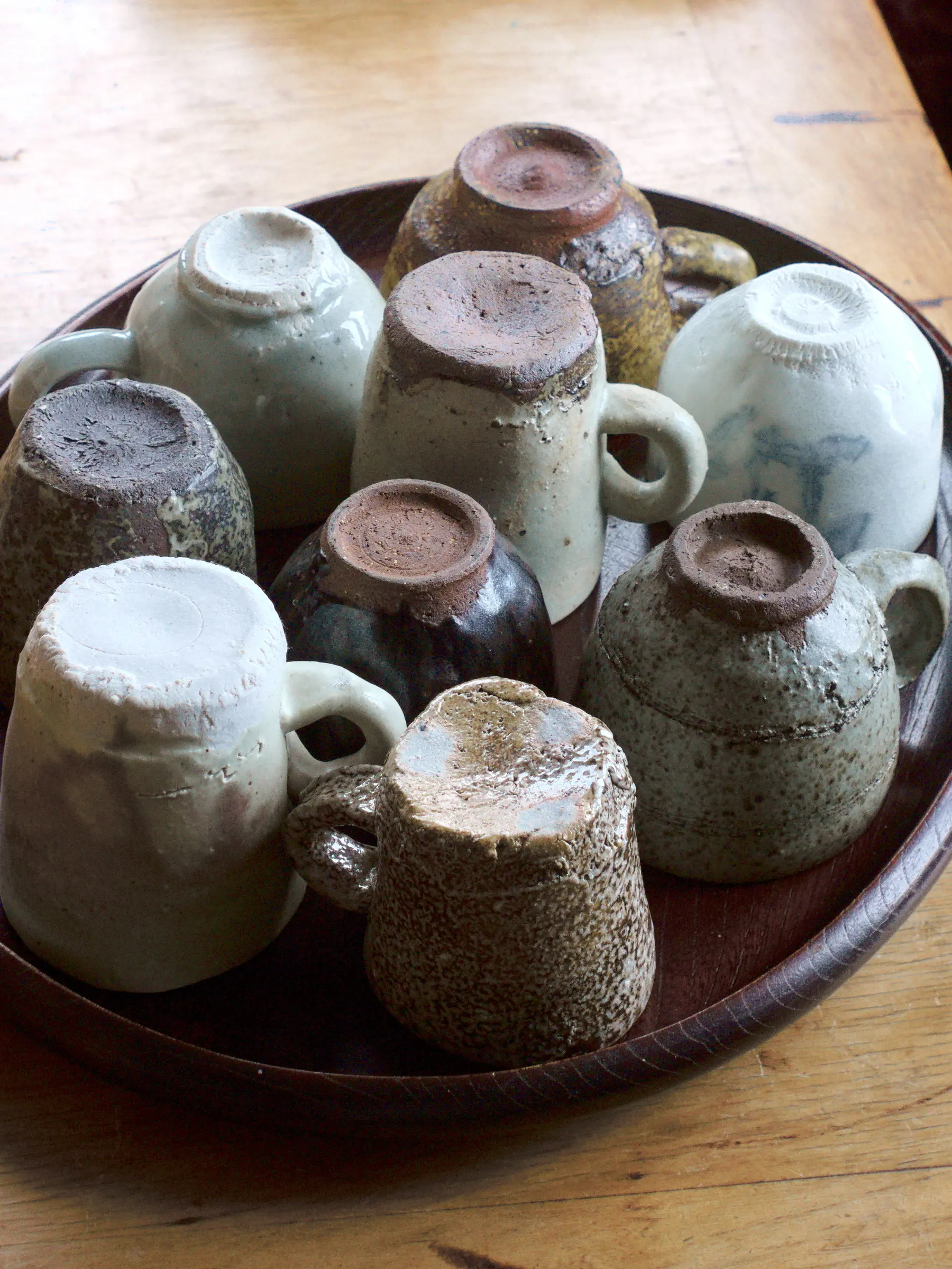 A collection of pottery cups on a tray