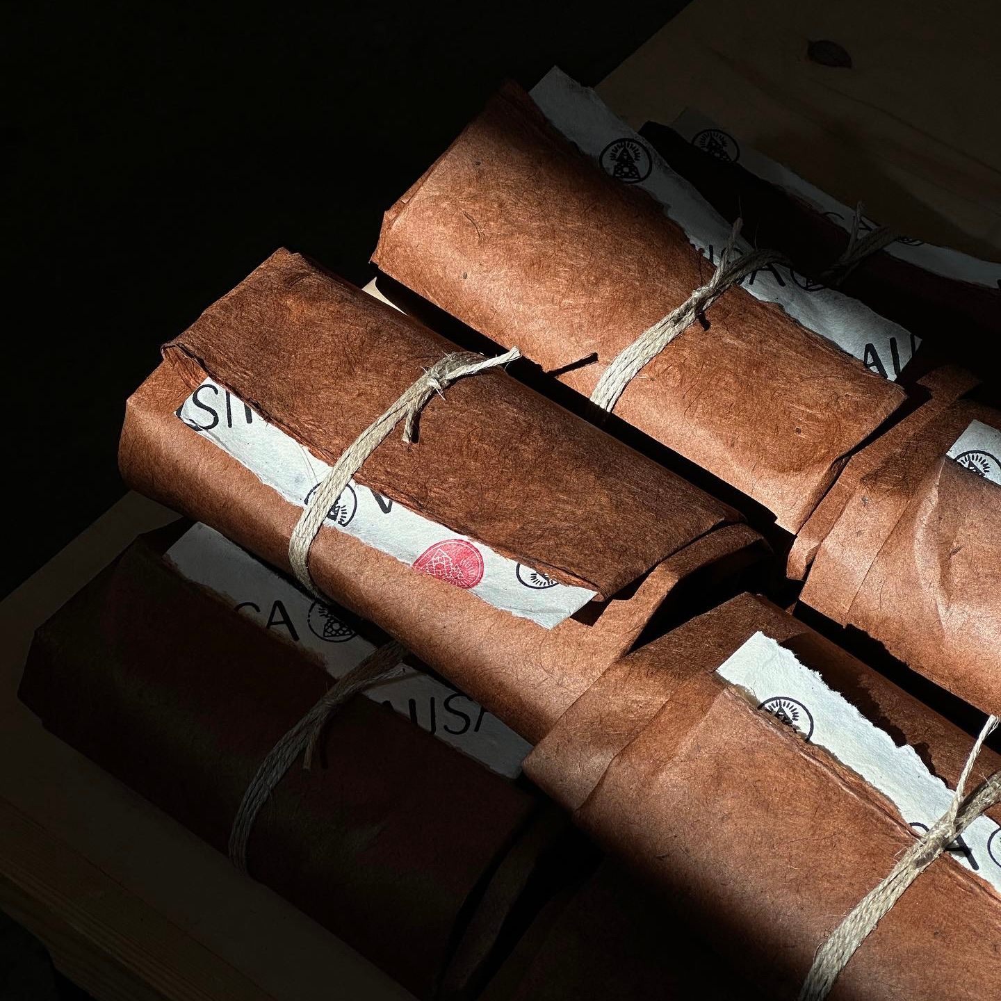 a bundle of incense parcels from Incausa with sun shining on them