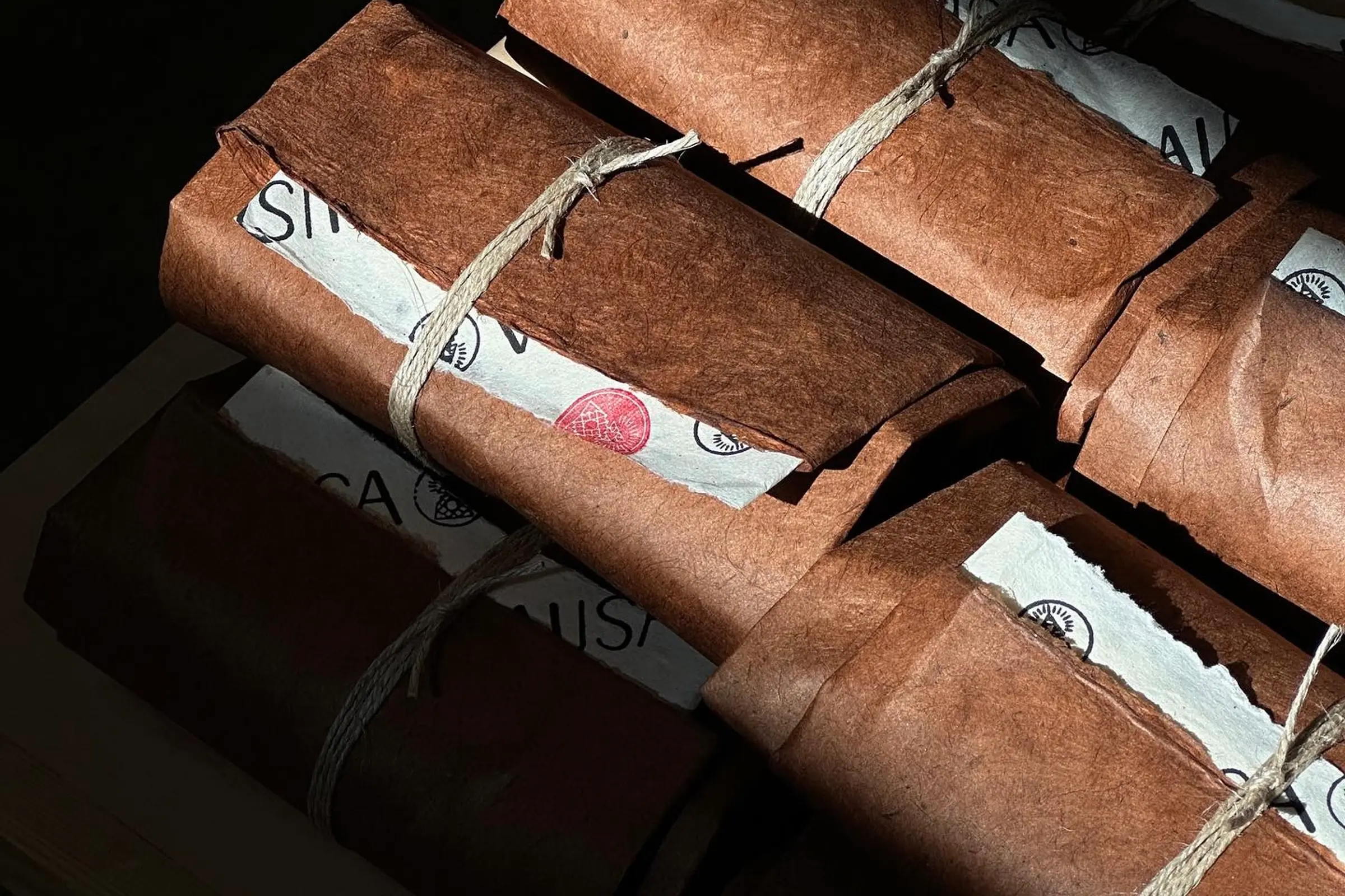 a bundle of incense parcels from Incausa with sun shining on them