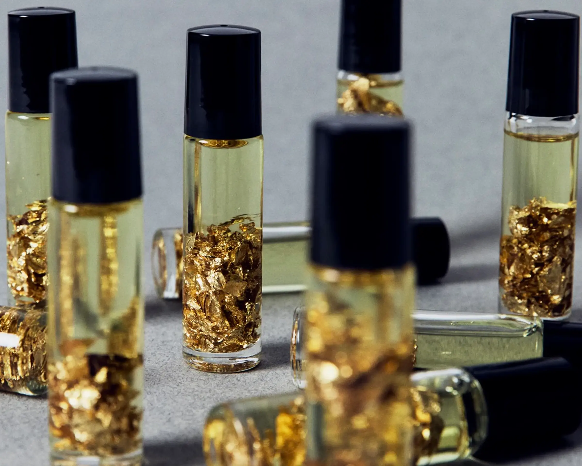bottles of anointing oil with gold leaf