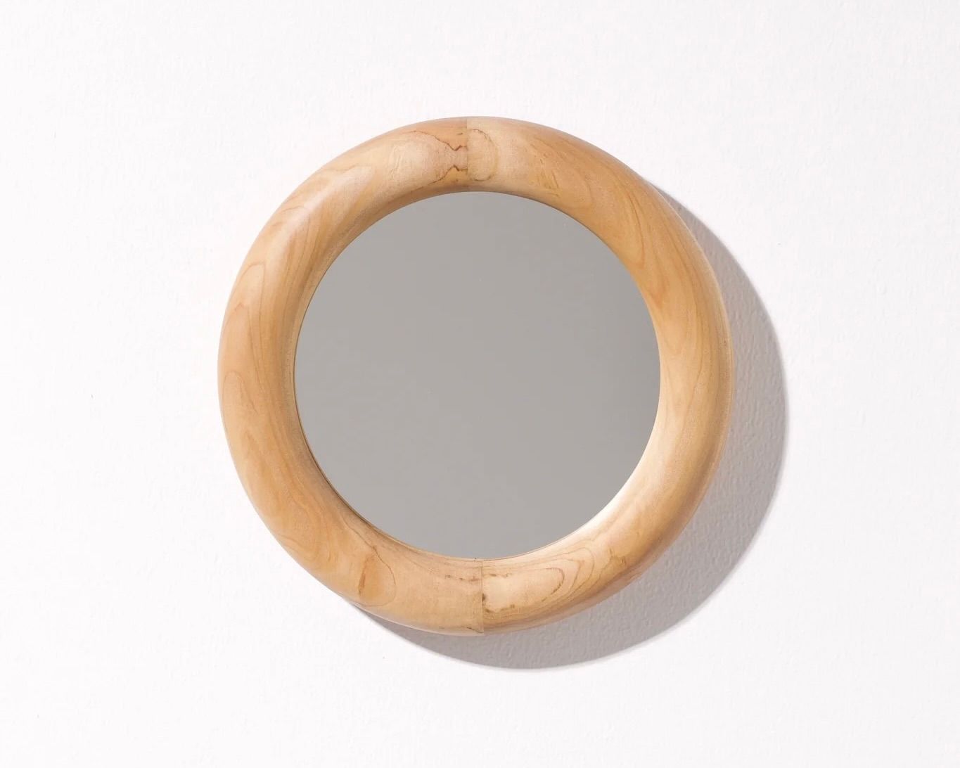 A hand carved Macrocarpa small mirror hand carved by New Zealand wood worker Courtney Petley