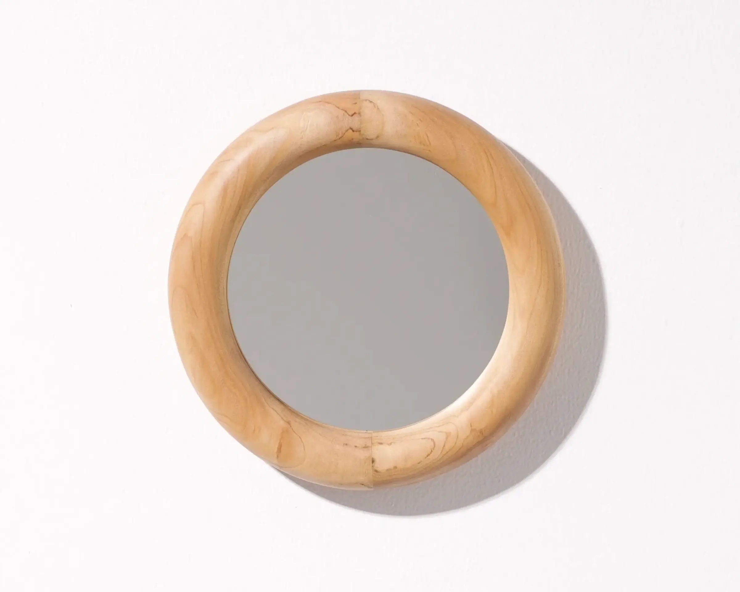 A hand carved Macrocarpa small mirror hand carved by New Zealand wood worker Courtney Petley