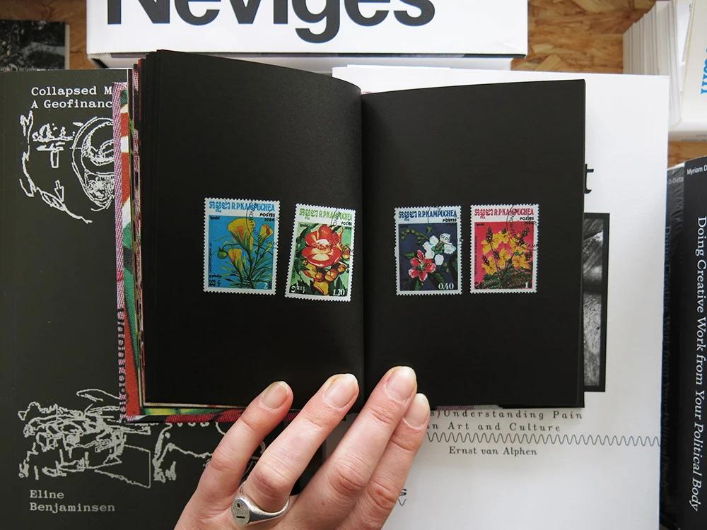 Flower Stamps by Charles Deroyan open to a spread featuring a collection of vintage Cuban postage stamps illustrated with flowers.