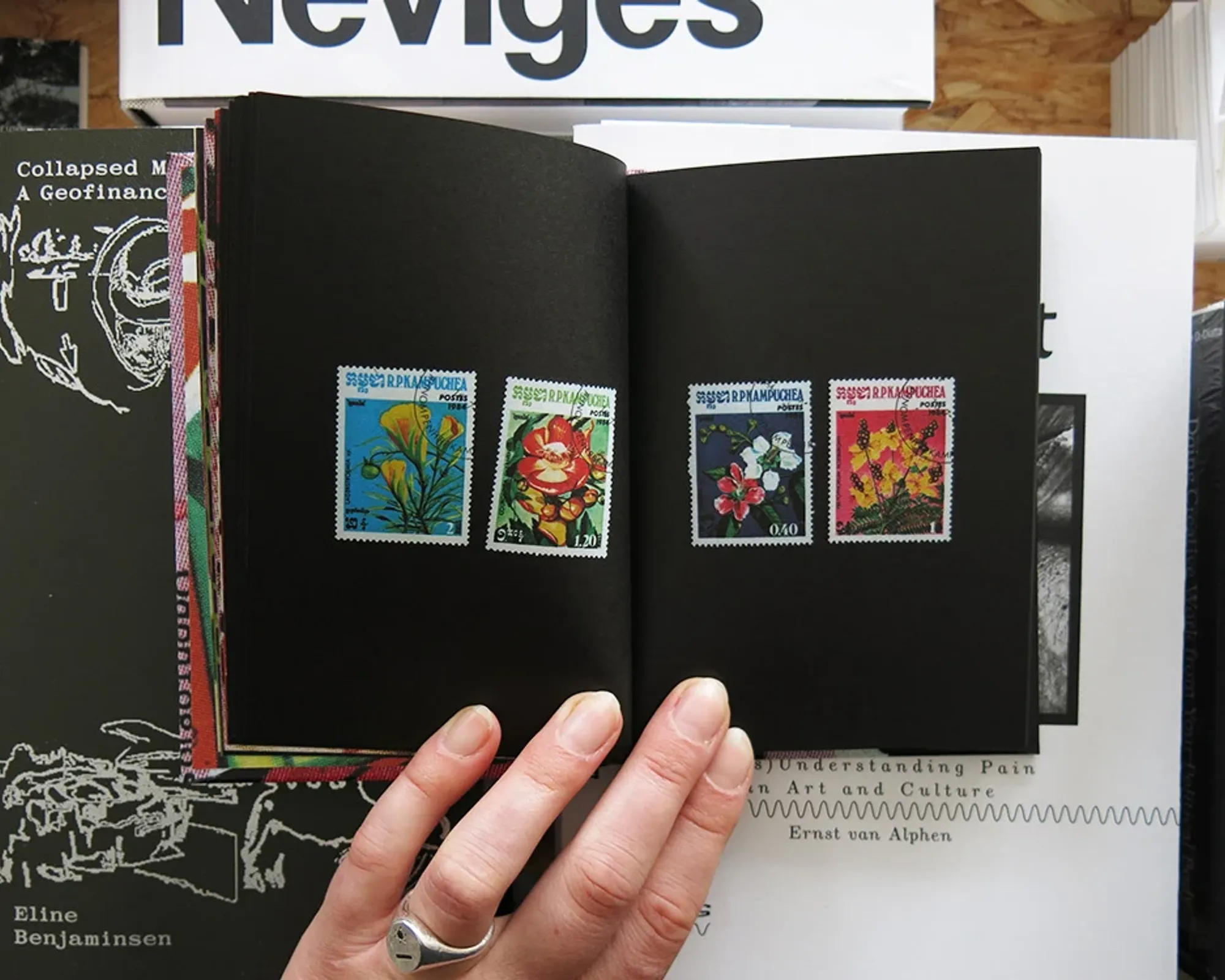Flower Stamps by Charles Deroyan open to a spread featuring a collection of vintage Cuban postage stamps illustrated with flowers.