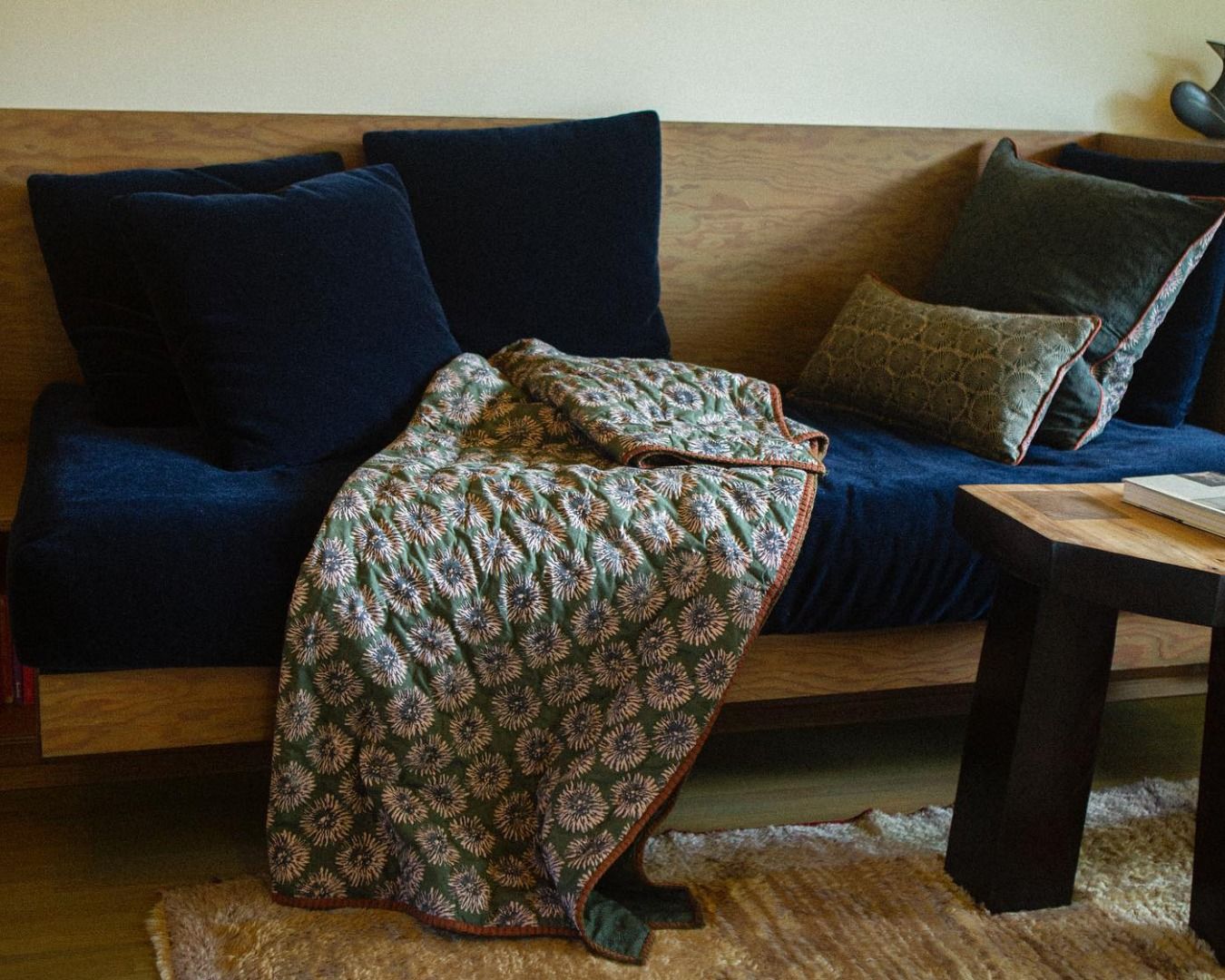 Studio fords blooming flower quilt on a couch in a living room