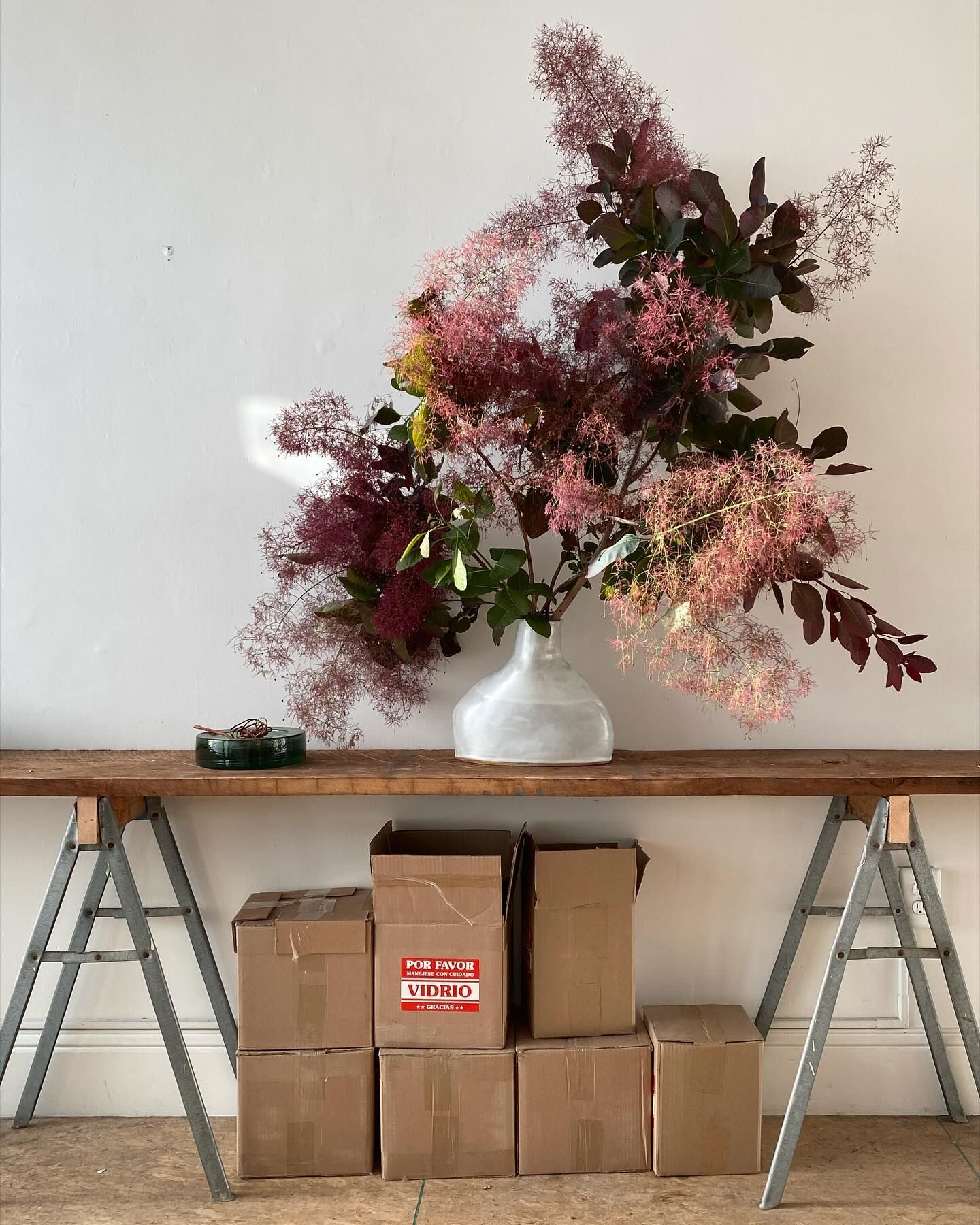 Flower arrangement on a trestle table with boxes underneath