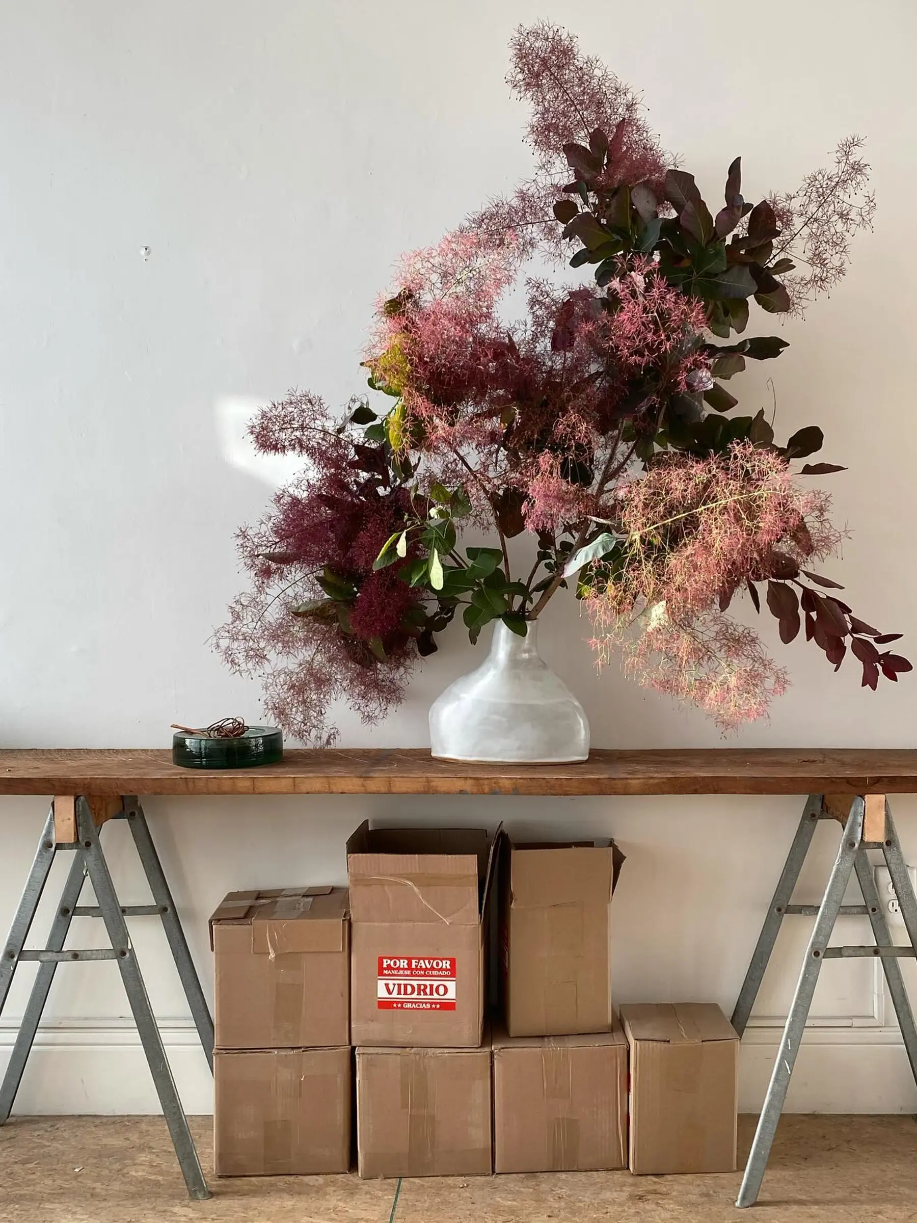 Flower arrangement on a trestle table with boxes underneath