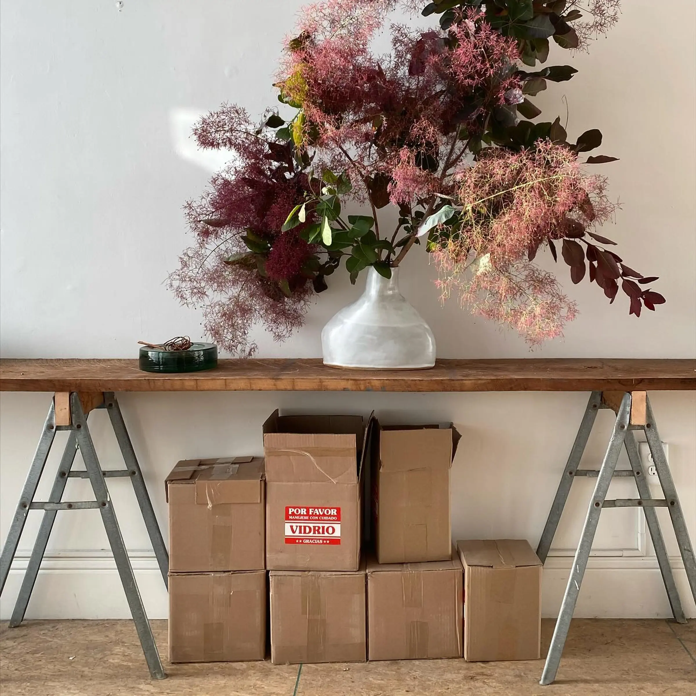 Flower arrangement on a trestle table with boxes underneath