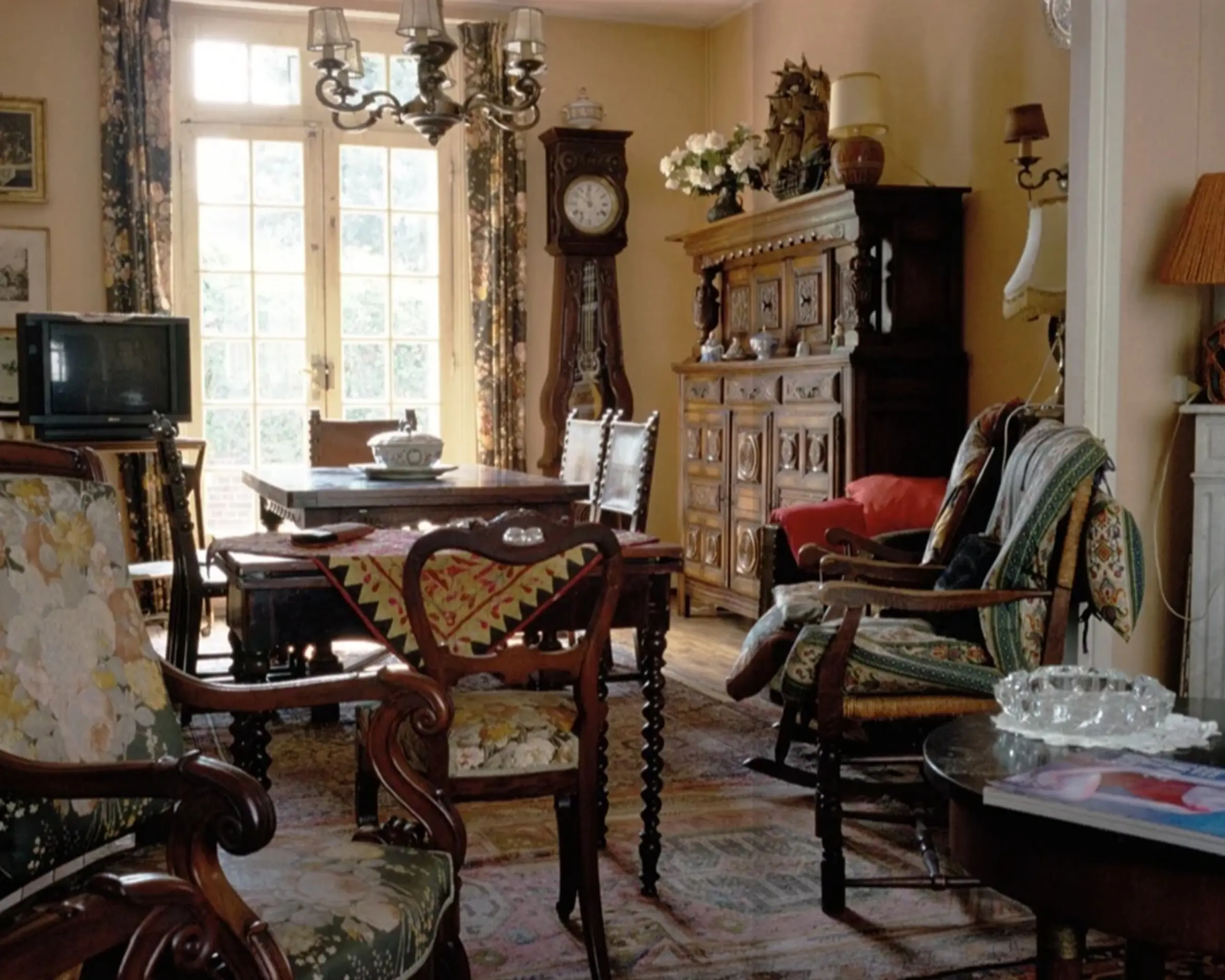 a photograph inside a living room with antique wooden furniture