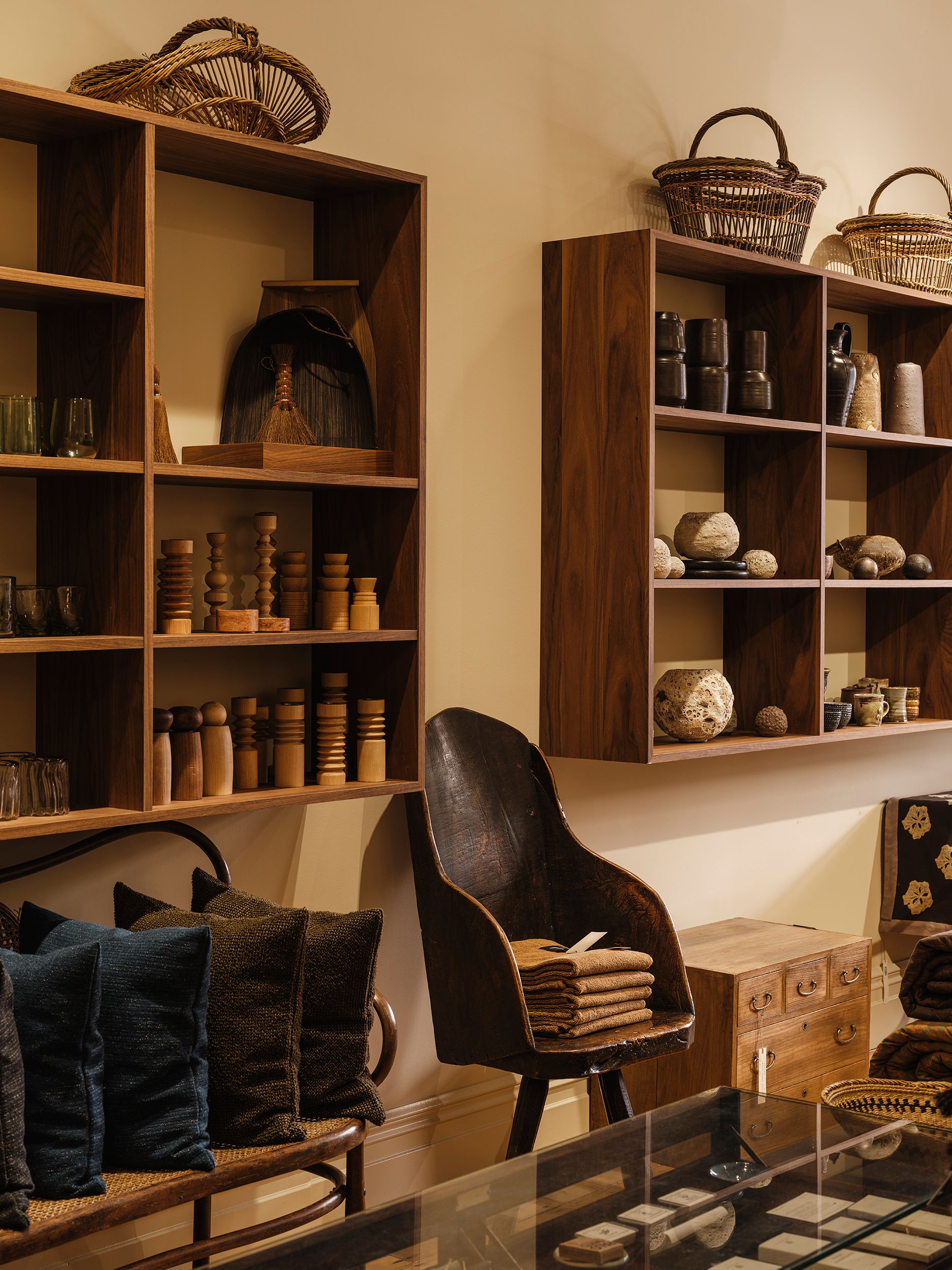 Front gallery of Handcrafted Modern with custom walnut shelving, heritage architecture and contemporary handcrafted objects.