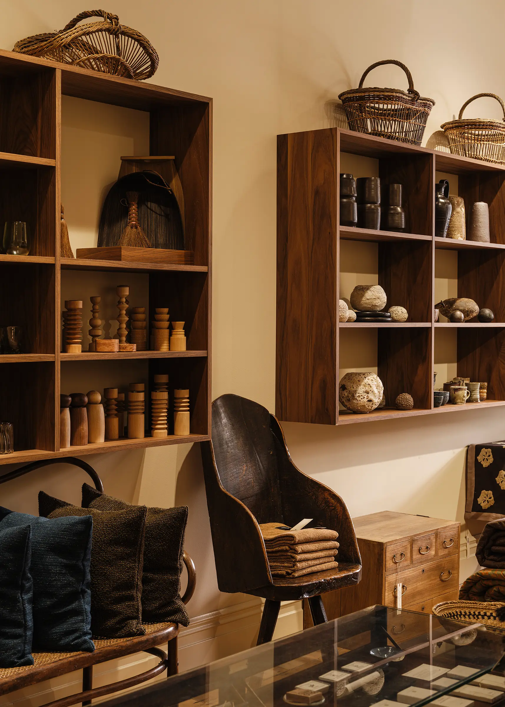 Front gallery of Handcrafted Modern with custom walnut shelving, heritage architecture and contemporary handcrafted objects.