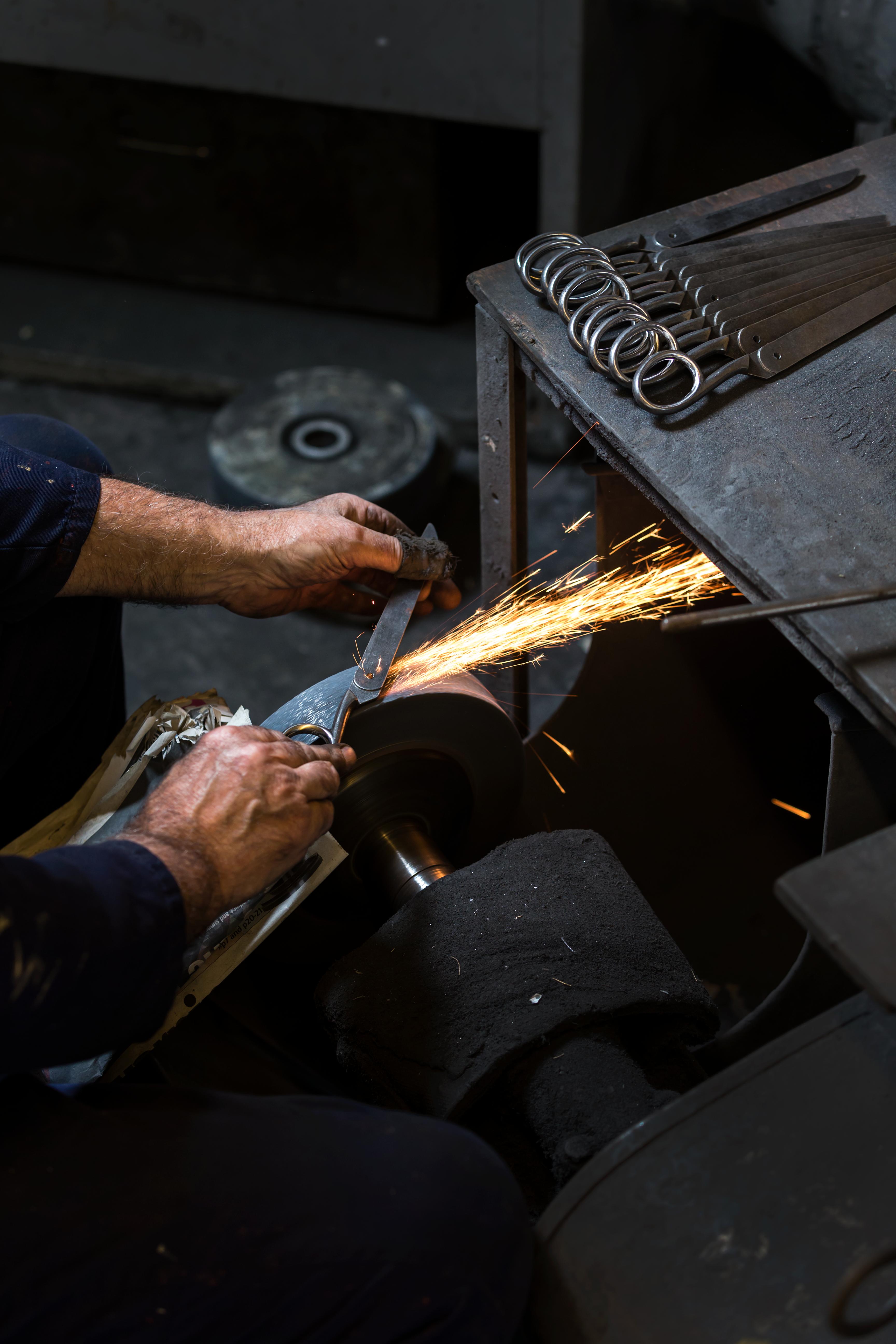 grinding blade of scissors being made
