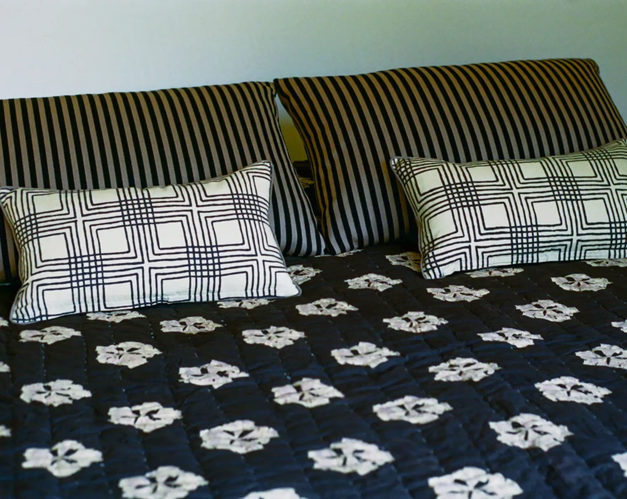 the studio ford leaflet quilt on a bed in situ