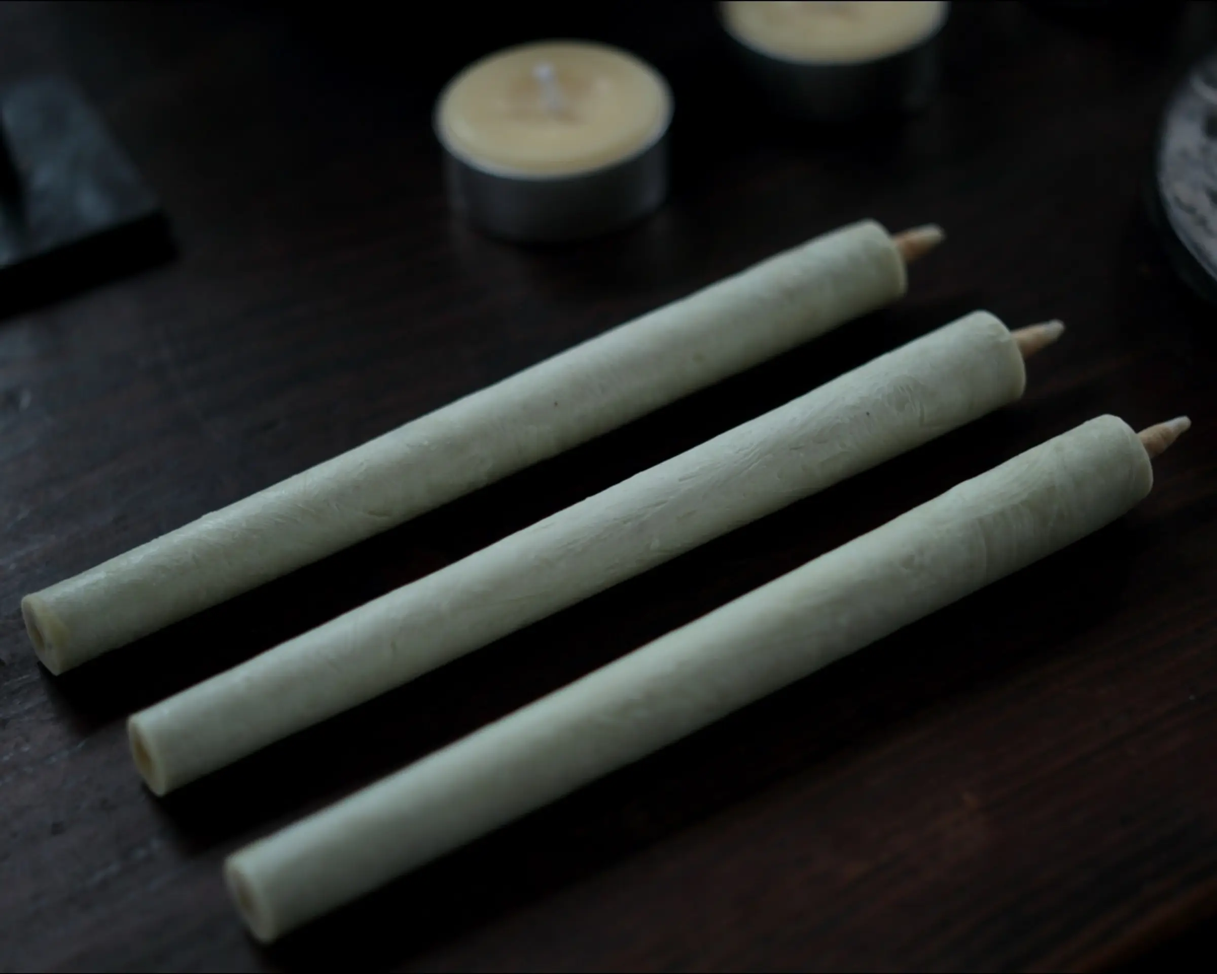 day sumac candles lined up on a table
