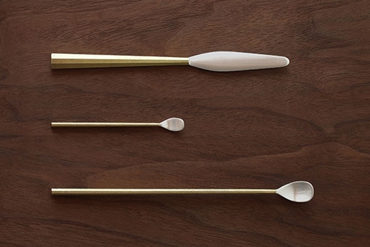 brass and silver knife and spoons