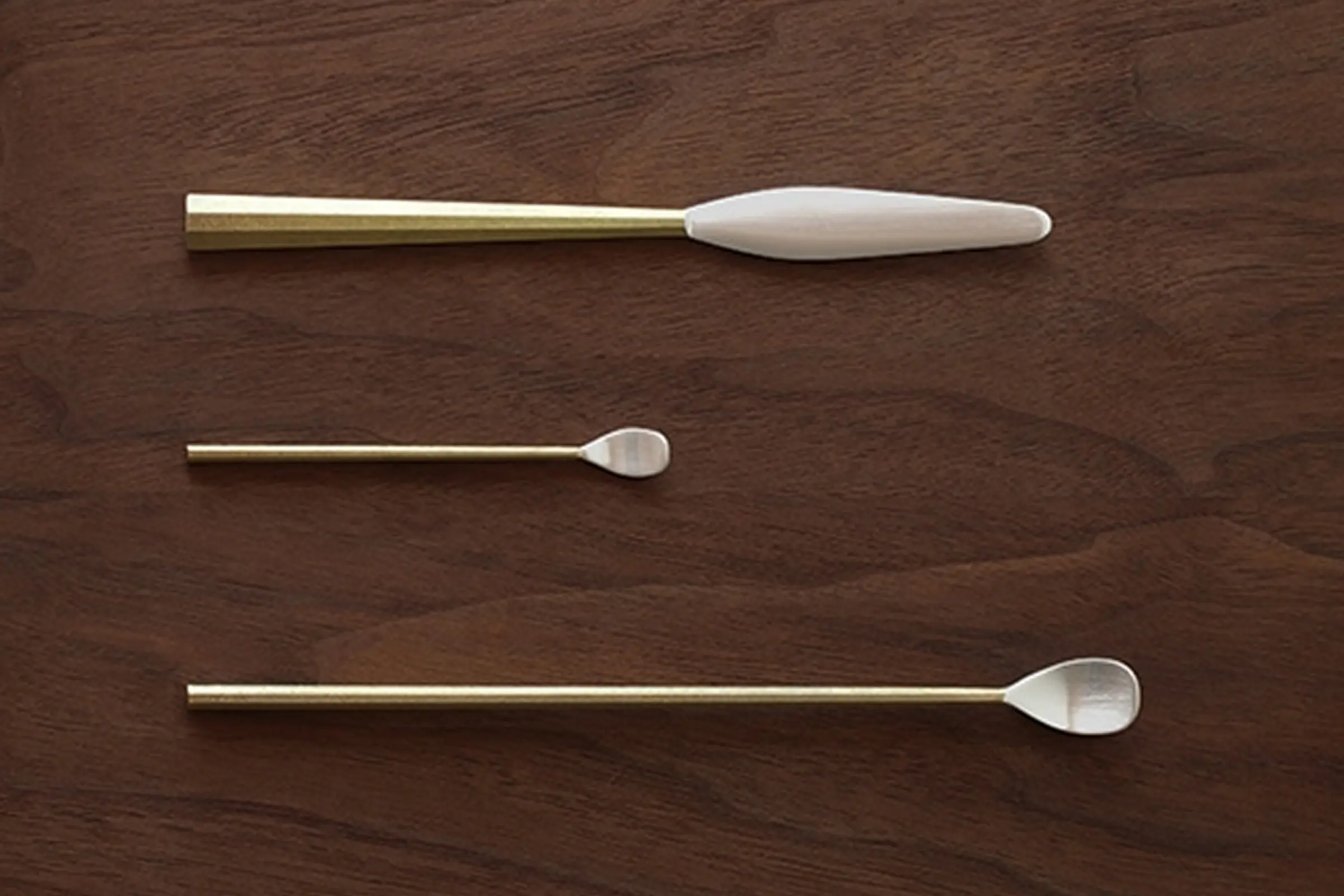 brass and silver knife and spoons