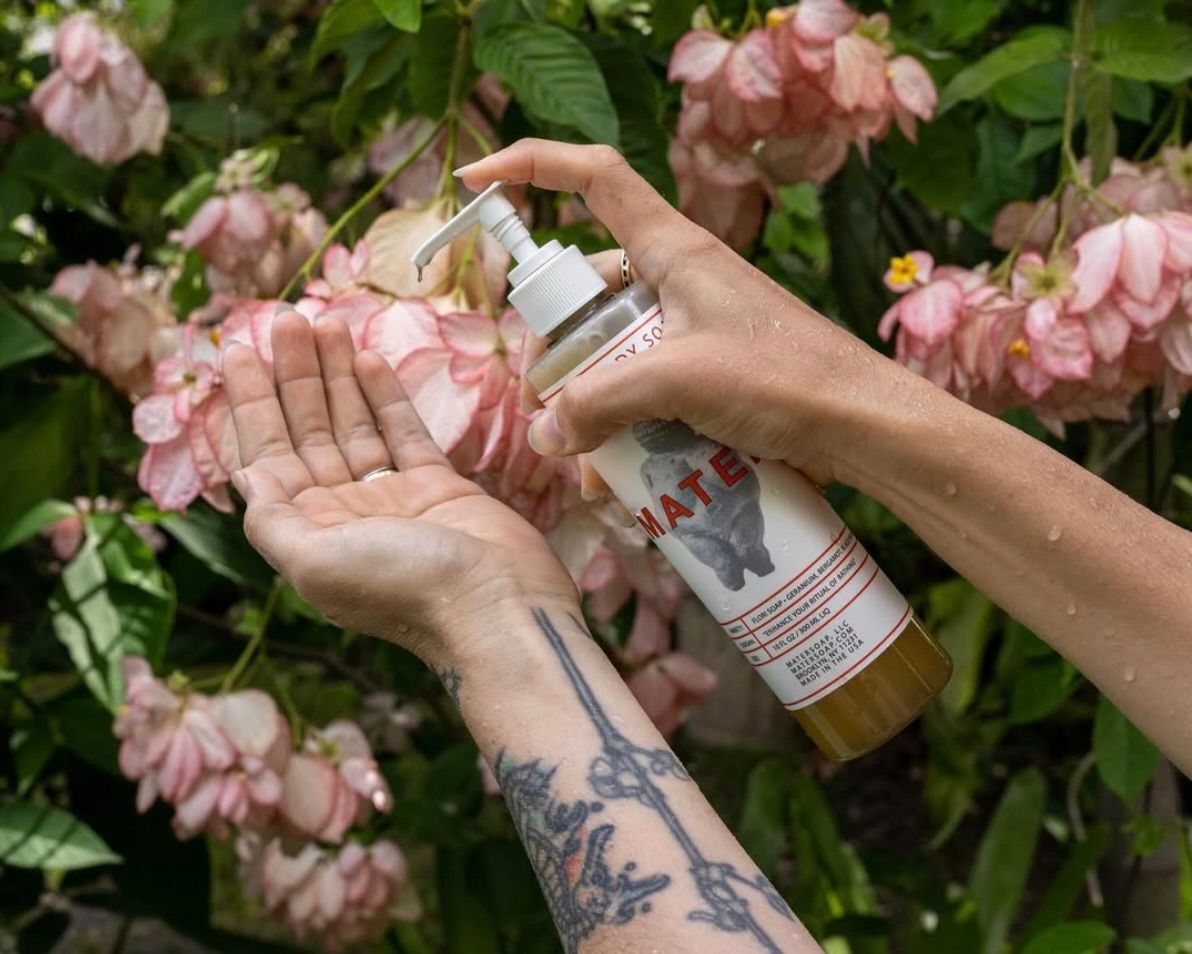 Mater Flori soap in  recycled PU bottle in front of a tree in bloom