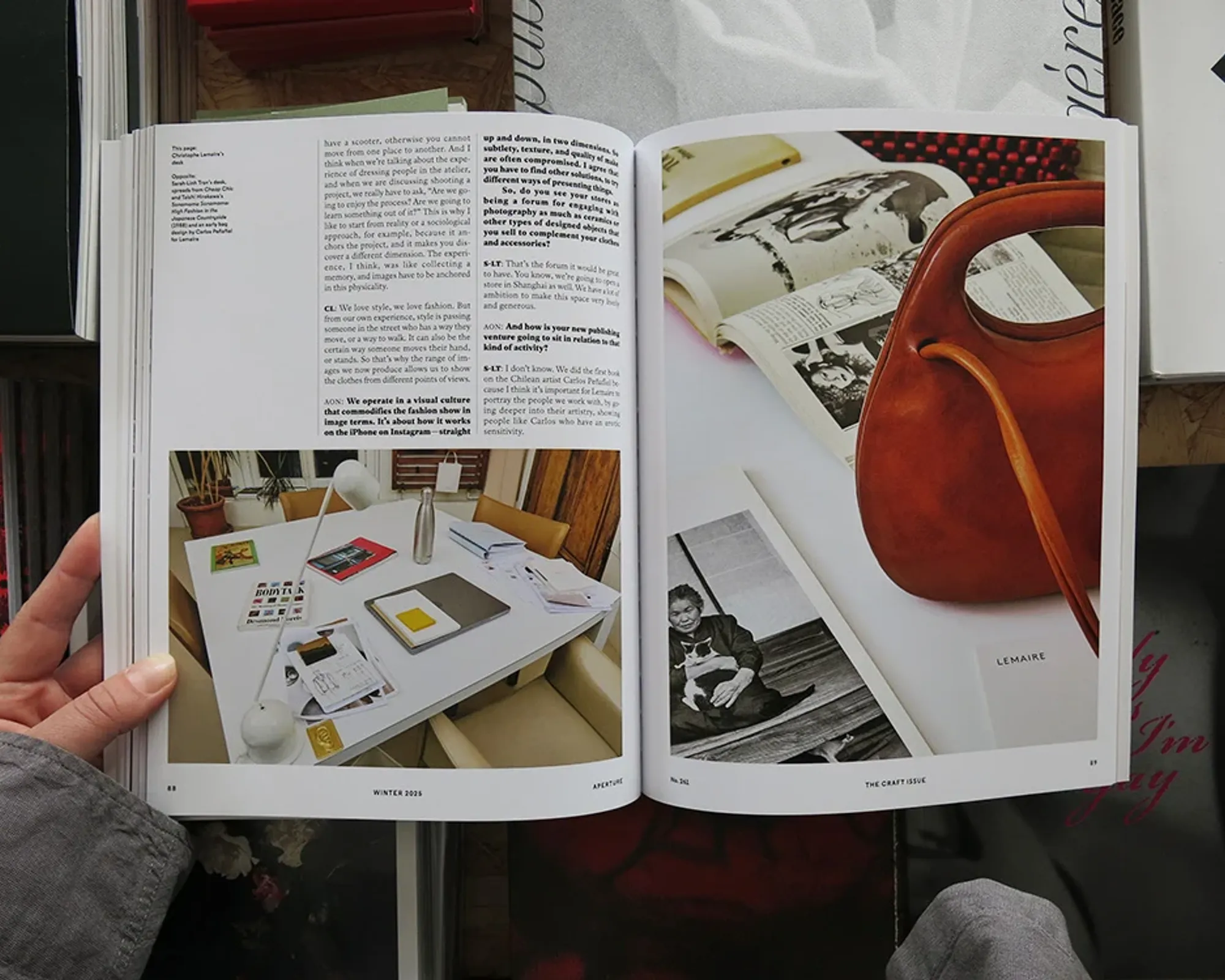 Aperture No. 261: The Craft Issue open to an interior spread featuring photography, books and a sculptural leather bag.