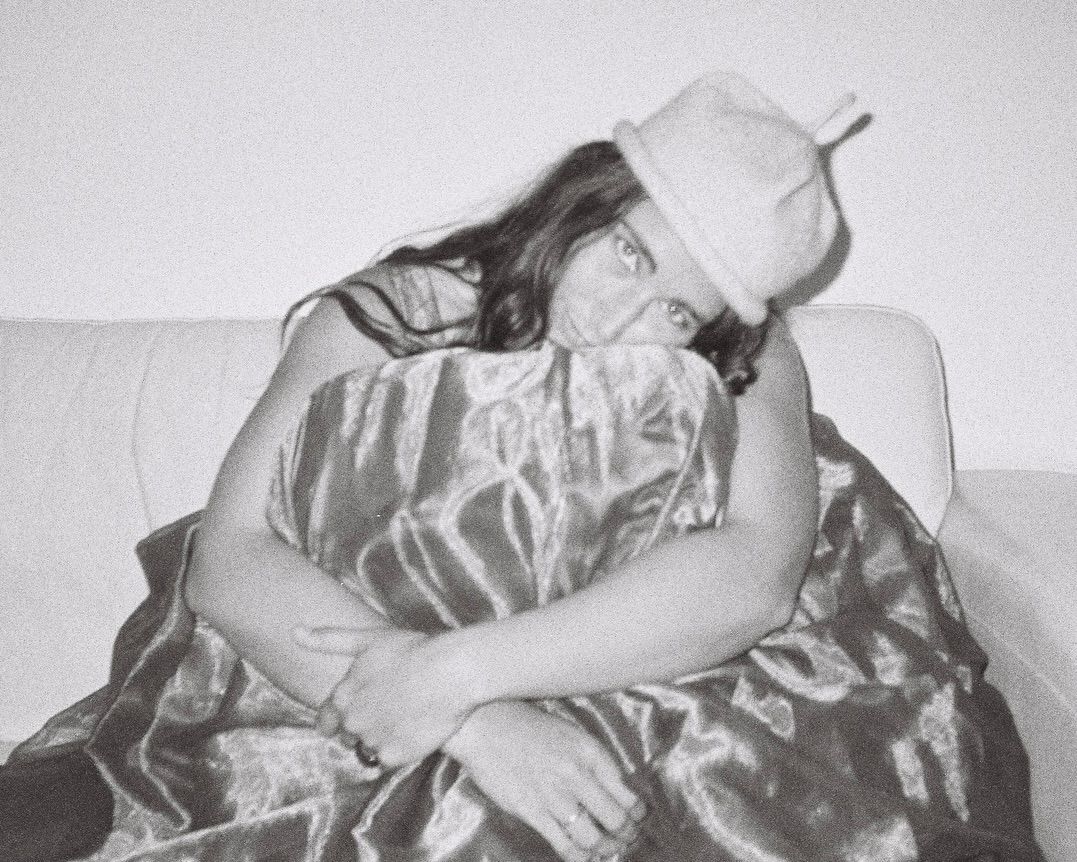 Woman wearing a Bonnie Wore hand knitted possum merino Loop Hat, handmade in New Zealand, black and white portrait.