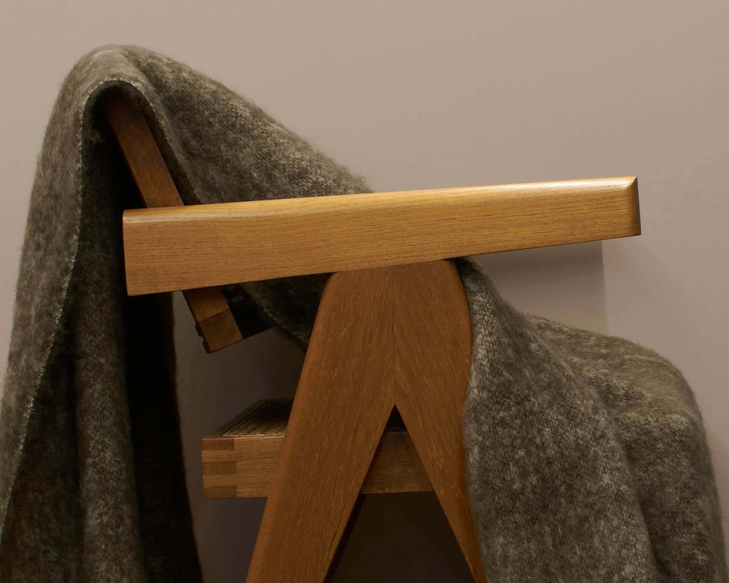 a mohair blanket draped over a wooden chair