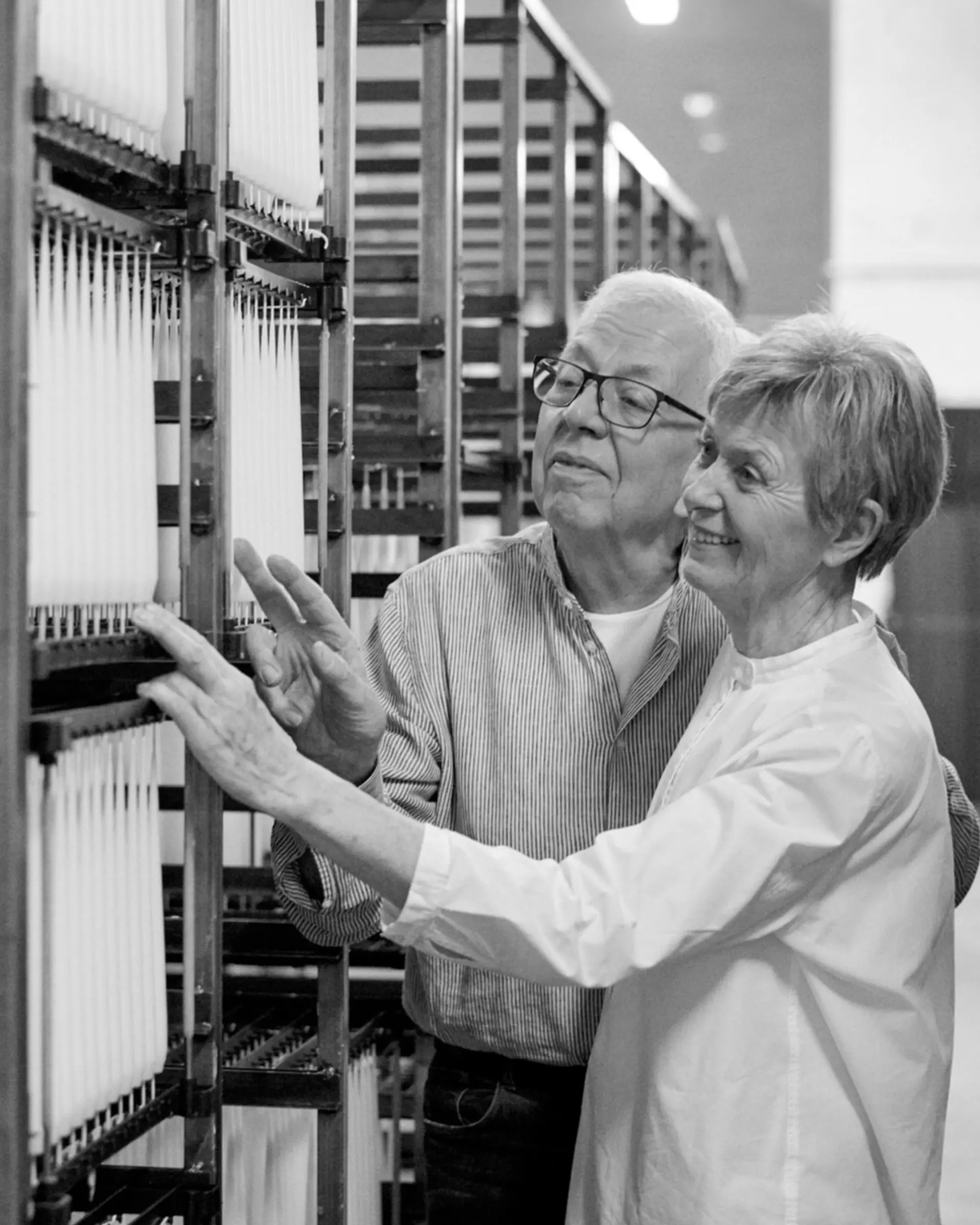 Ester & Erik, candles makers looking at their stock shelves of candles