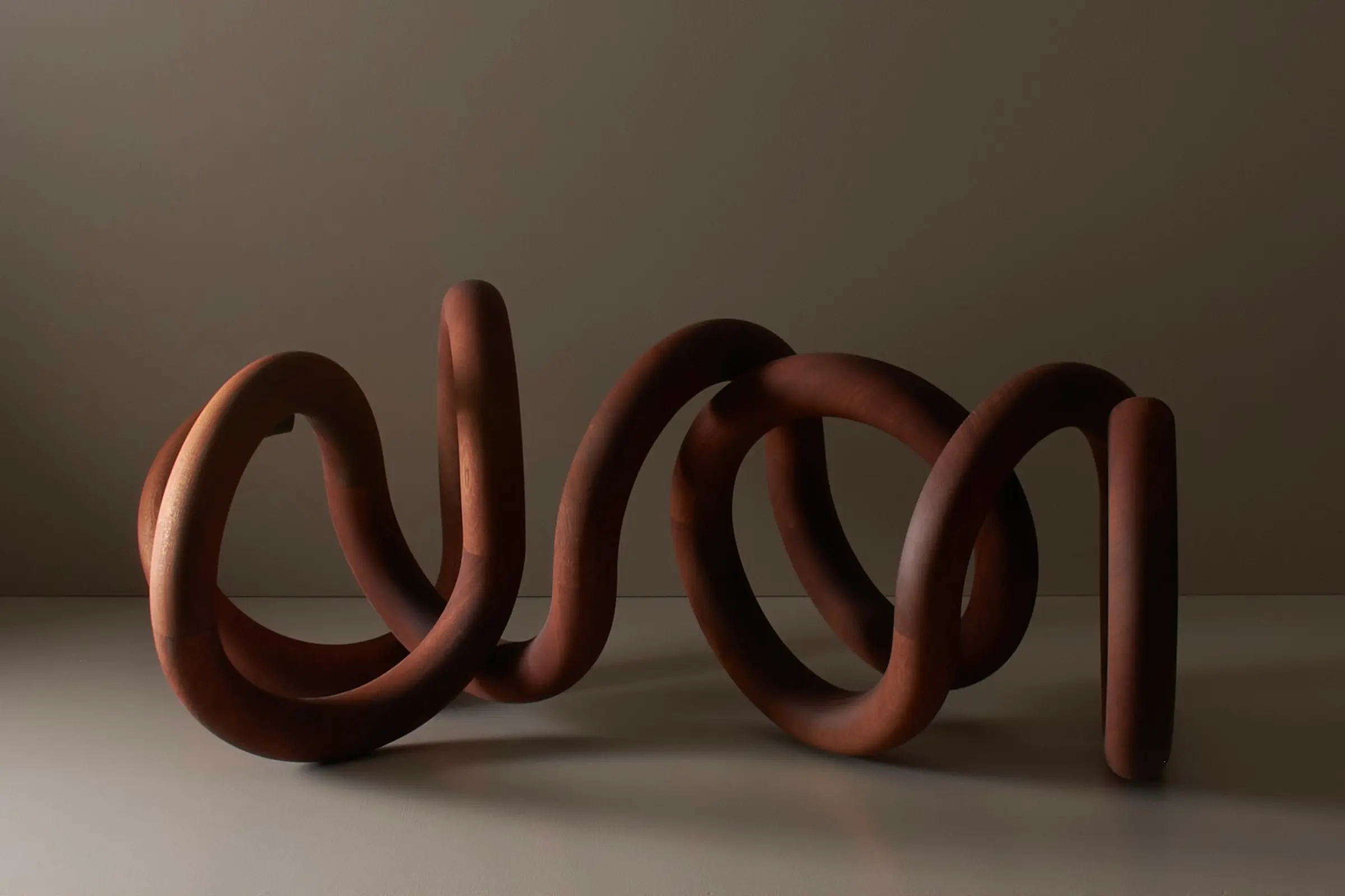 Graham Williams wood sculpture a curved endless tubular string form