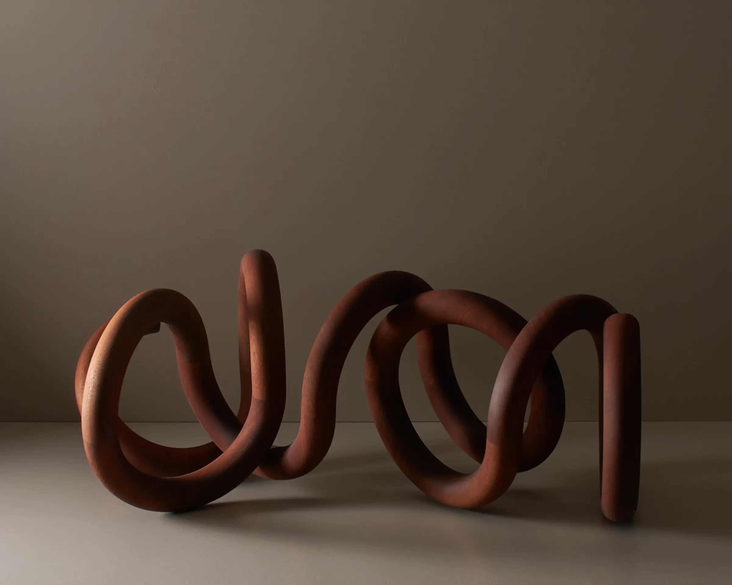 wooden sculpture in a continuing spiral form