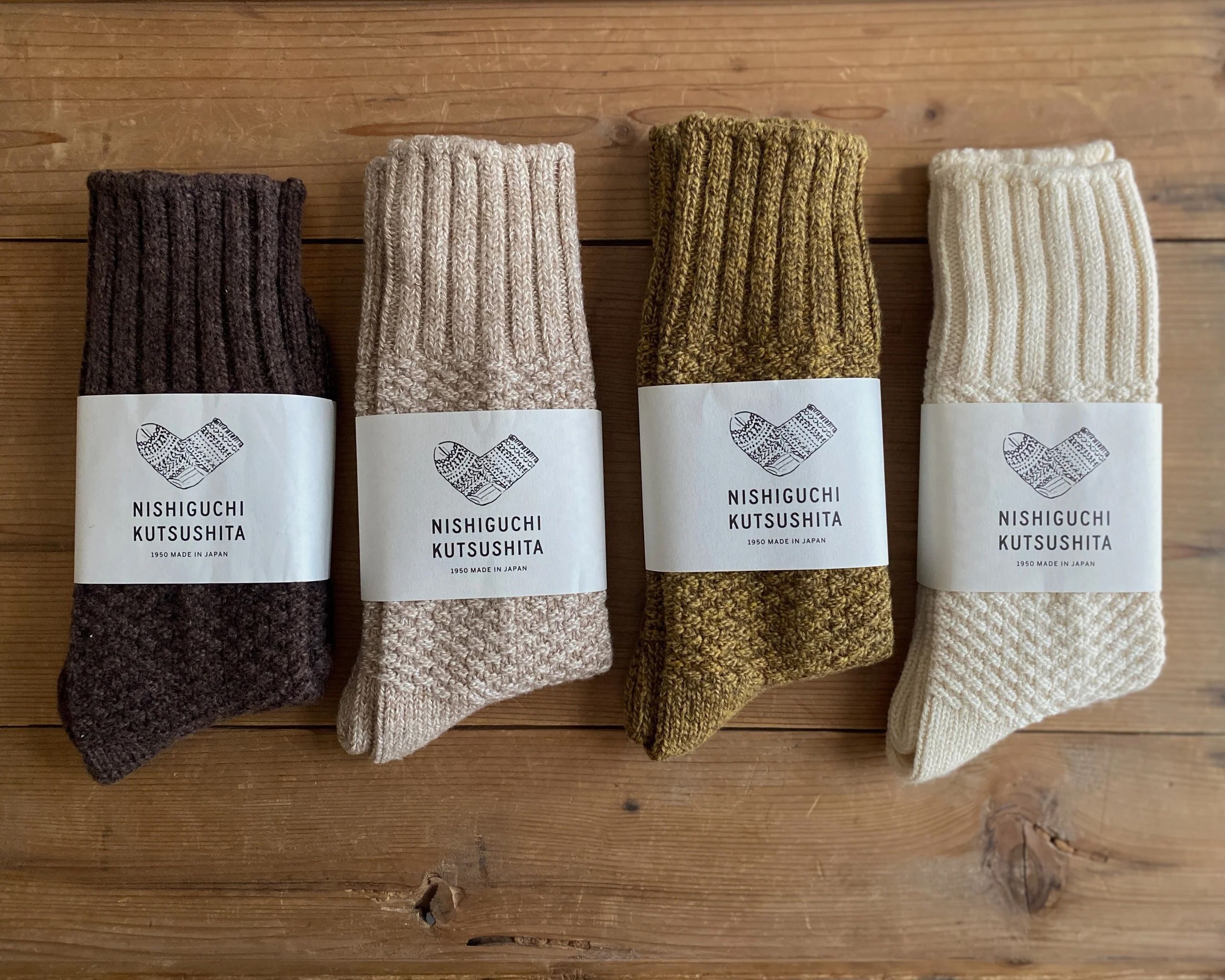 A collection of wool cotton boot socks on a wooden flooring