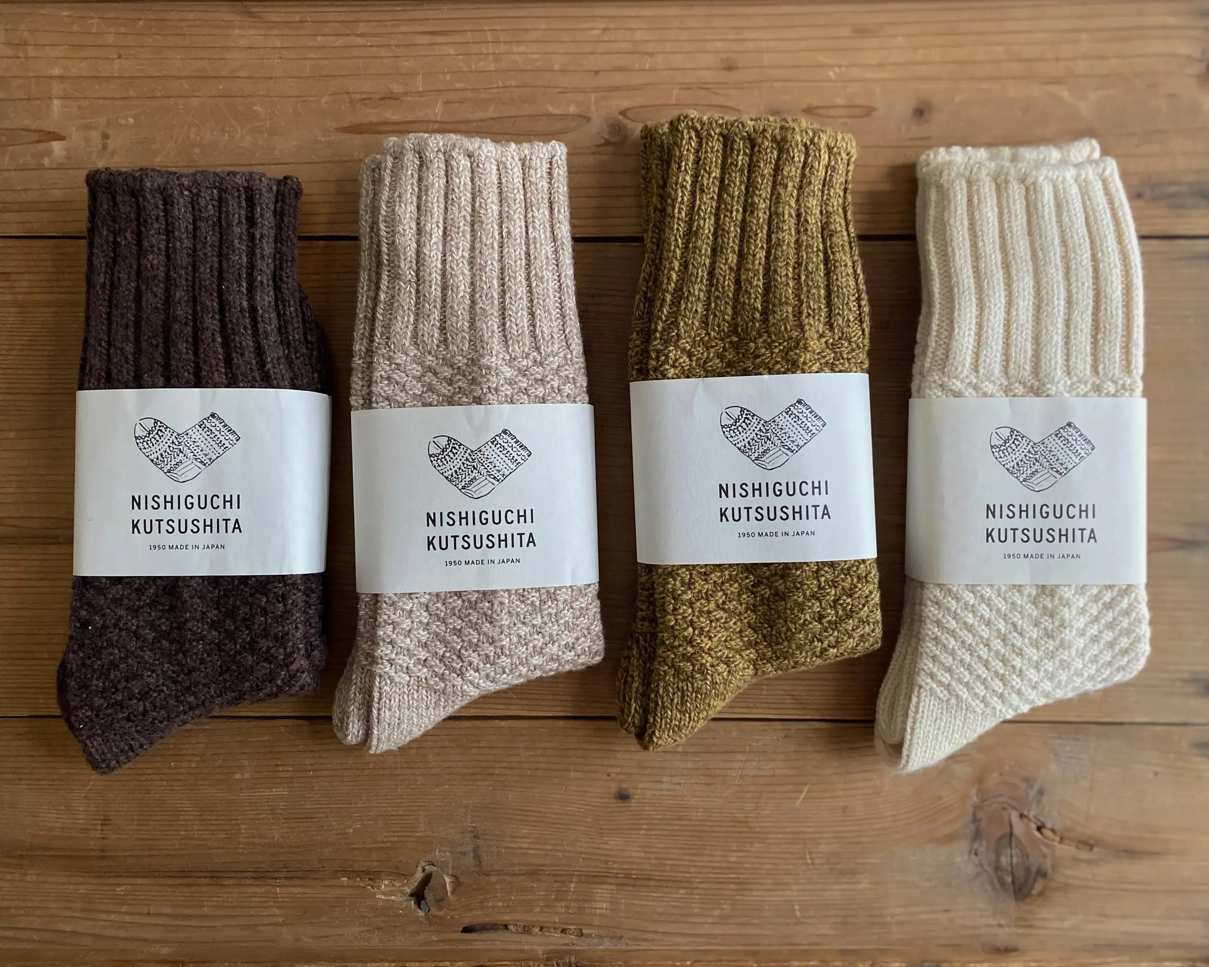 A collection of wool cotton boot socks on a wooden flooring