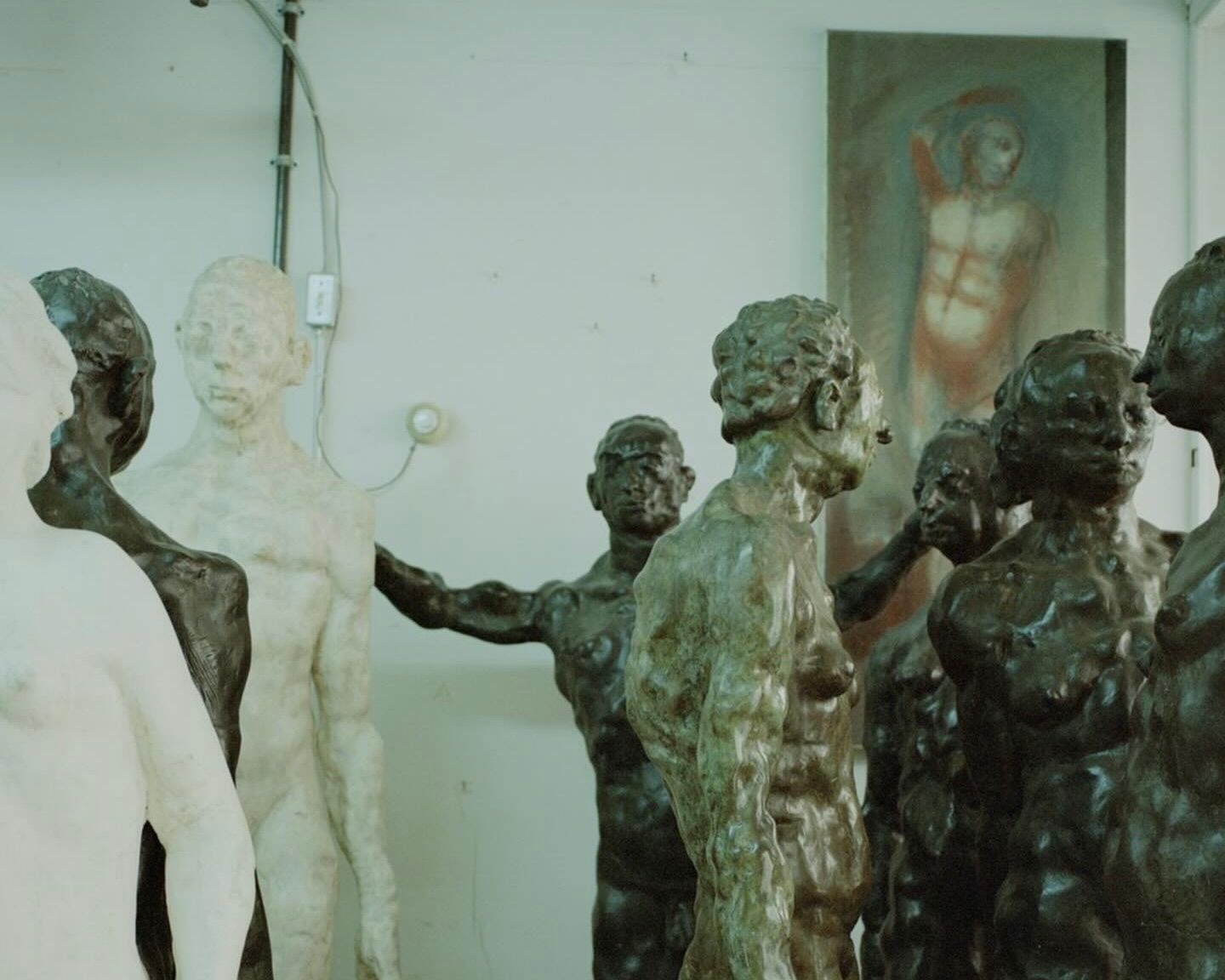 An image from Neptune papers issue 9 of a room with multiple sculptures of men in different colours, cream, green, bronze
