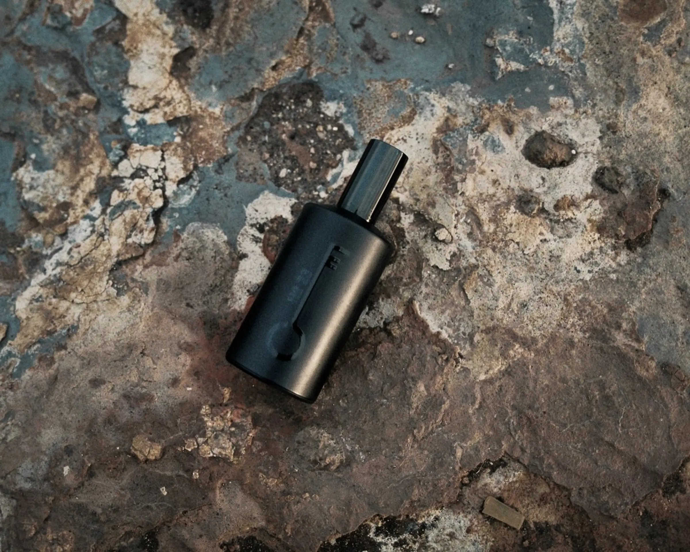 bottle of fischersund fragrance onto of beach rocks