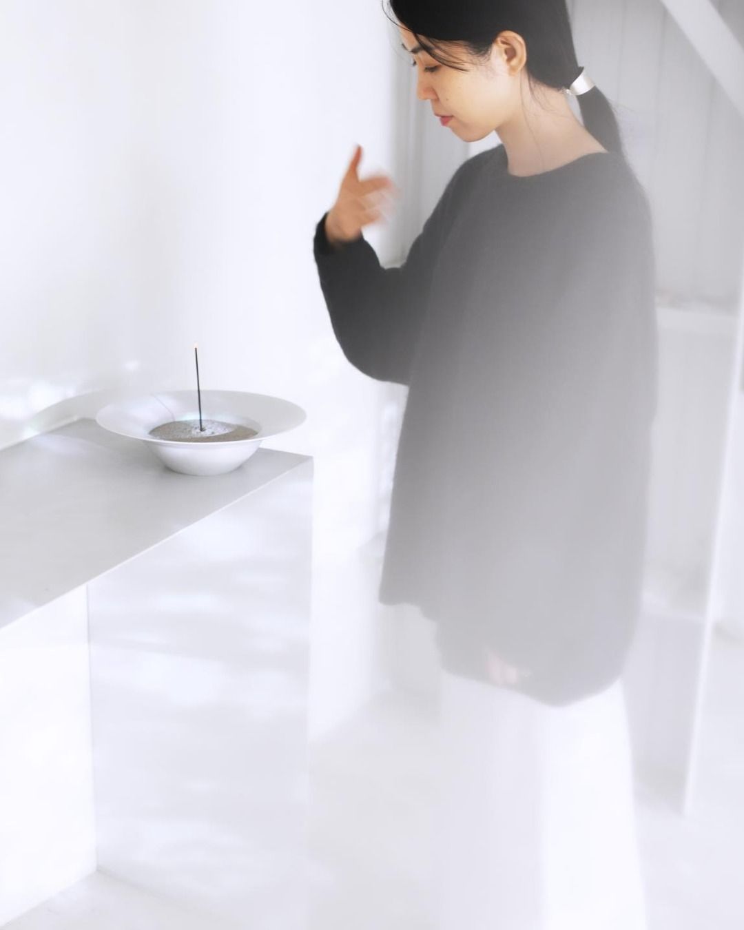 creator of Tokyo Kodo incense wafting the scent from a lit incense