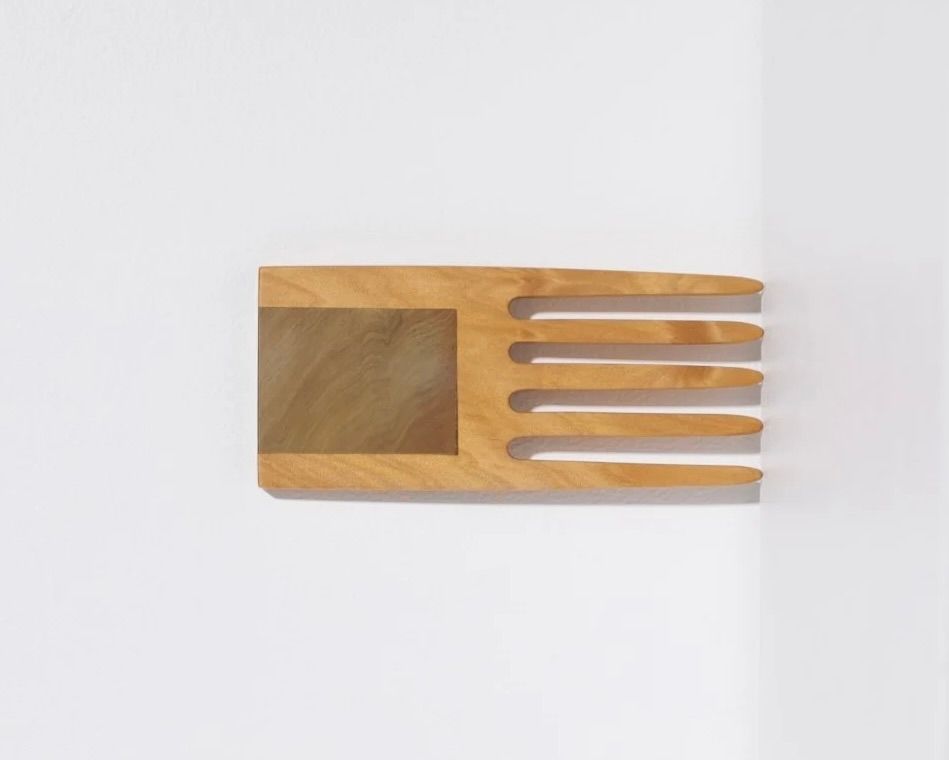 A hand carved inset wide tooth hair comb from Courtney Petleys 100 piece series hand made in Aotearoa, New Zealand