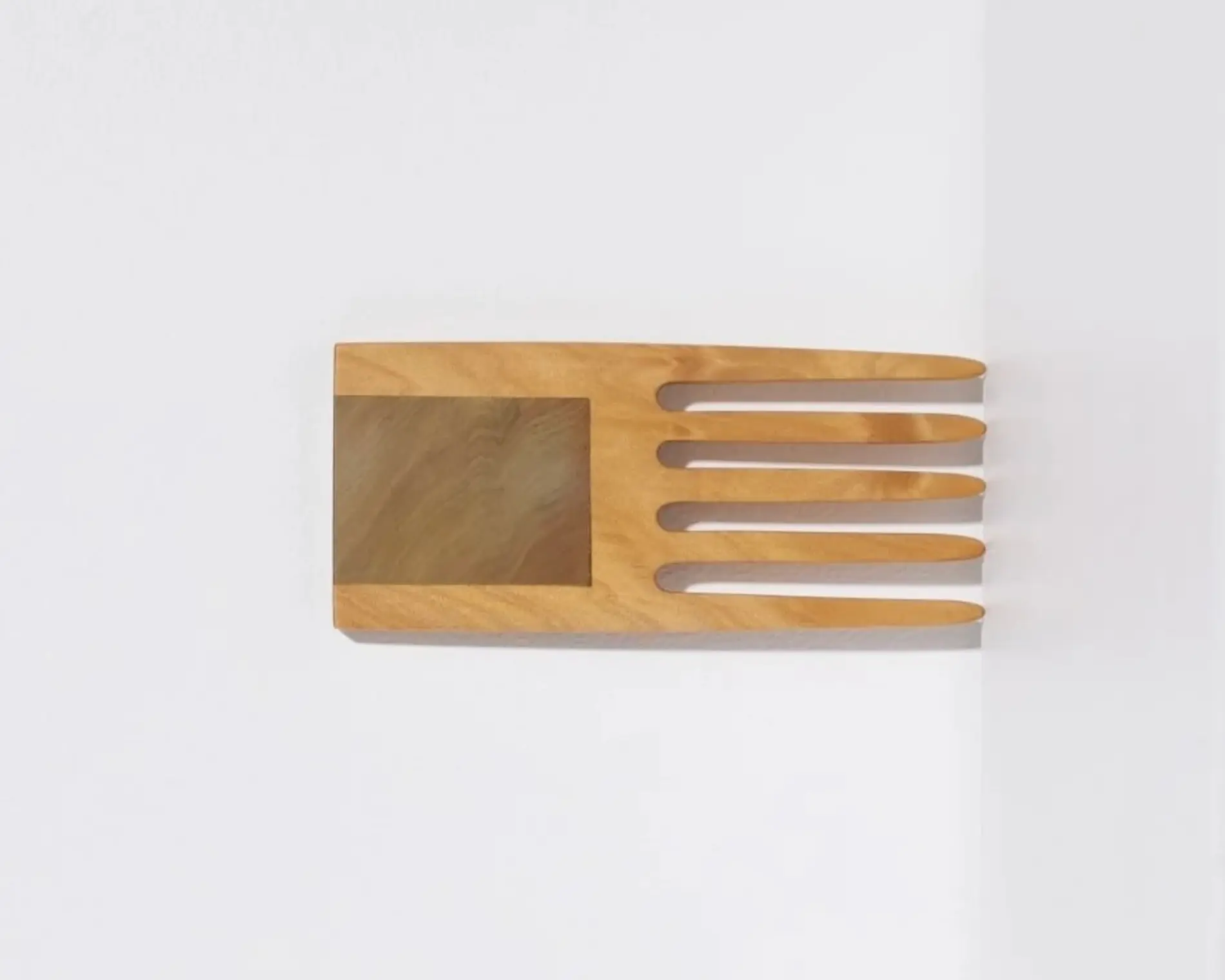 A hand carved inset wide tooth hair comb from Courtney Petleys 100 piece series hand made in Aotearoa, New Zealand