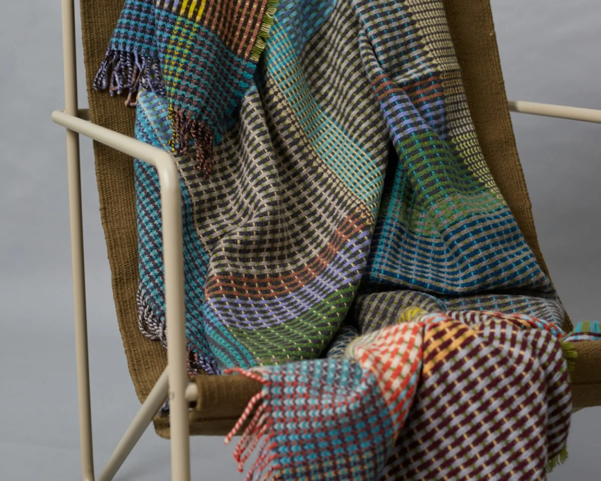 a close up shot of a wool blanket on a chair