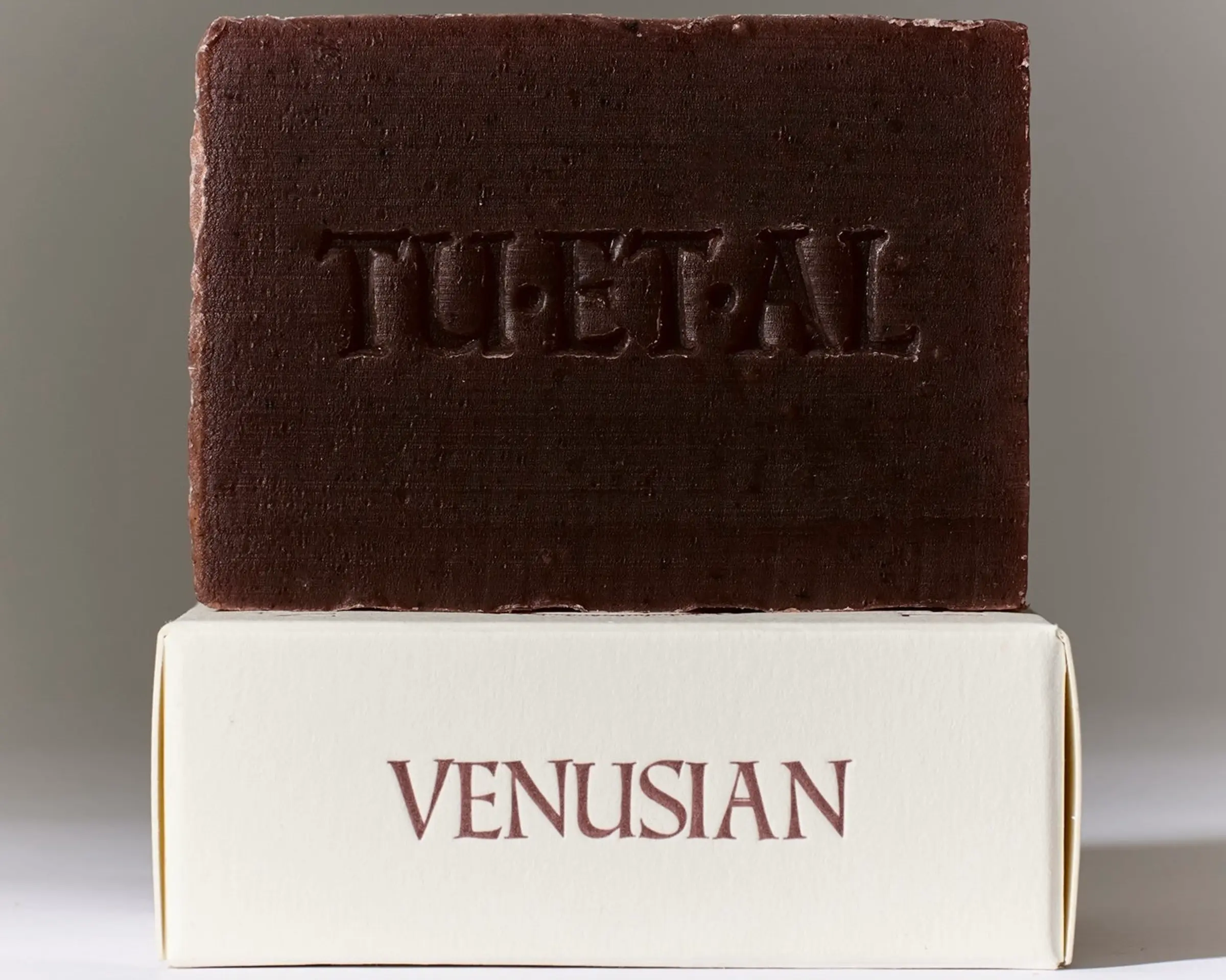 Tuétal Venusian cold process bar soap handcrafted with madder root, botanical oils and floral essential oils in a deep burgundy bar.