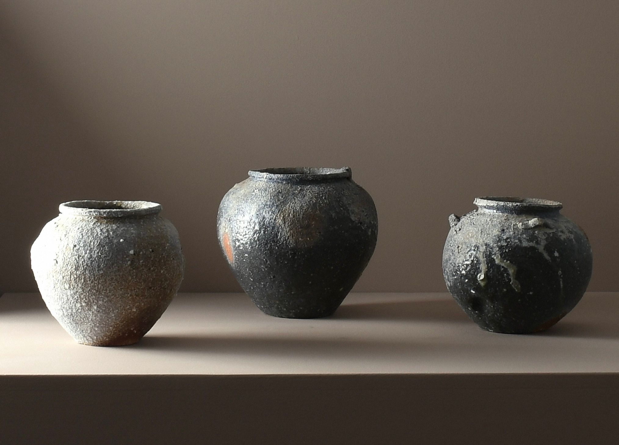 A trio of A one-of-a-kind stoneware vases by Aotearoa ceramic artist Holly Rose Morgan, made in Japan from Japanese Shigaraki clay before travelling to New Zealand to be wood-fired in the historic anagama kiln at Kamaka Pottery, Bridge Pā.