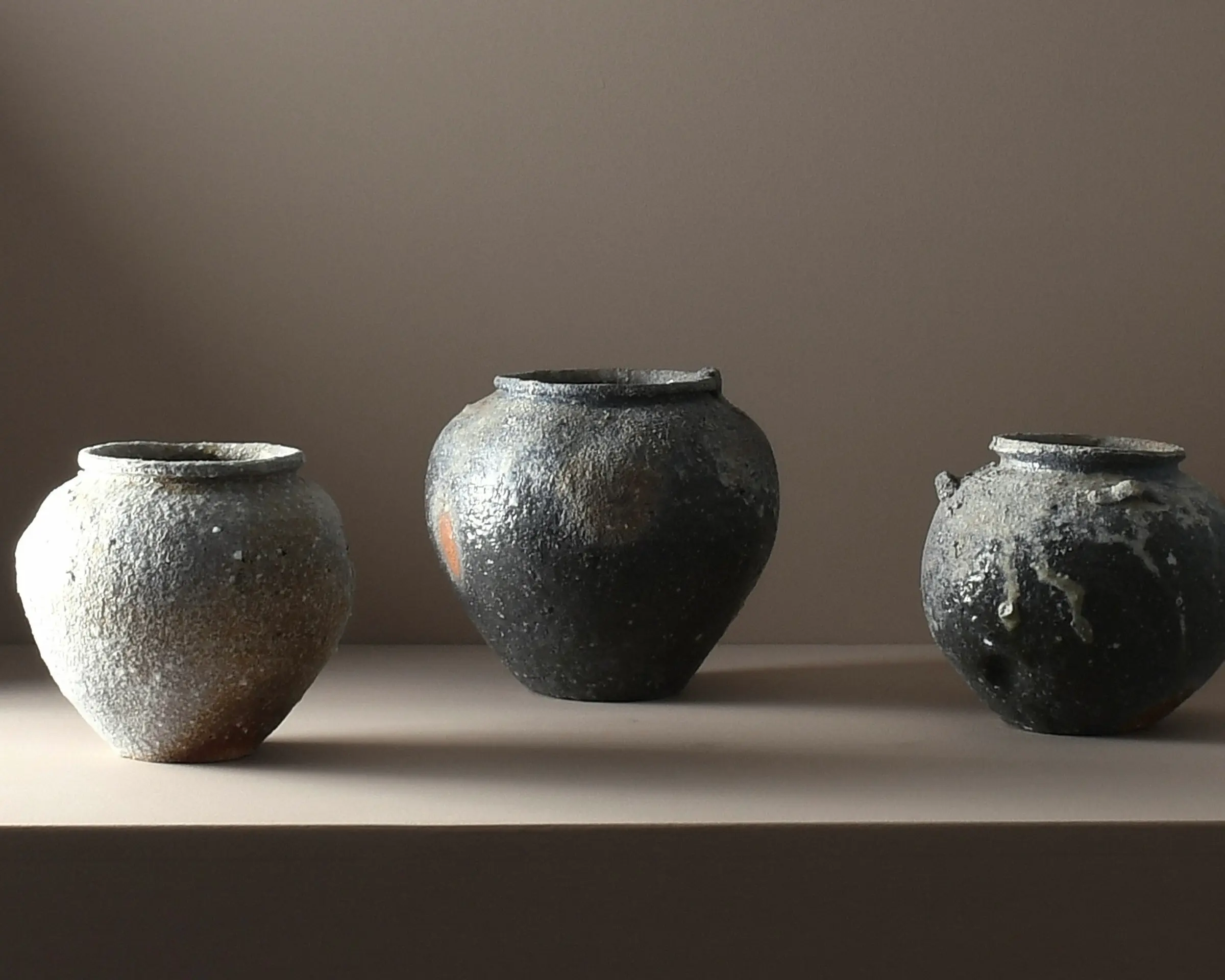 A trio of A one-of-a-kind stoneware vases by Aotearoa ceramic artist Holly Rose Morgan, made in Japan from Japanese Shigaraki clay before travelling to New Zealand to be wood-fired in the historic anagama kiln at Kamaka Pottery, Bridge Pā.