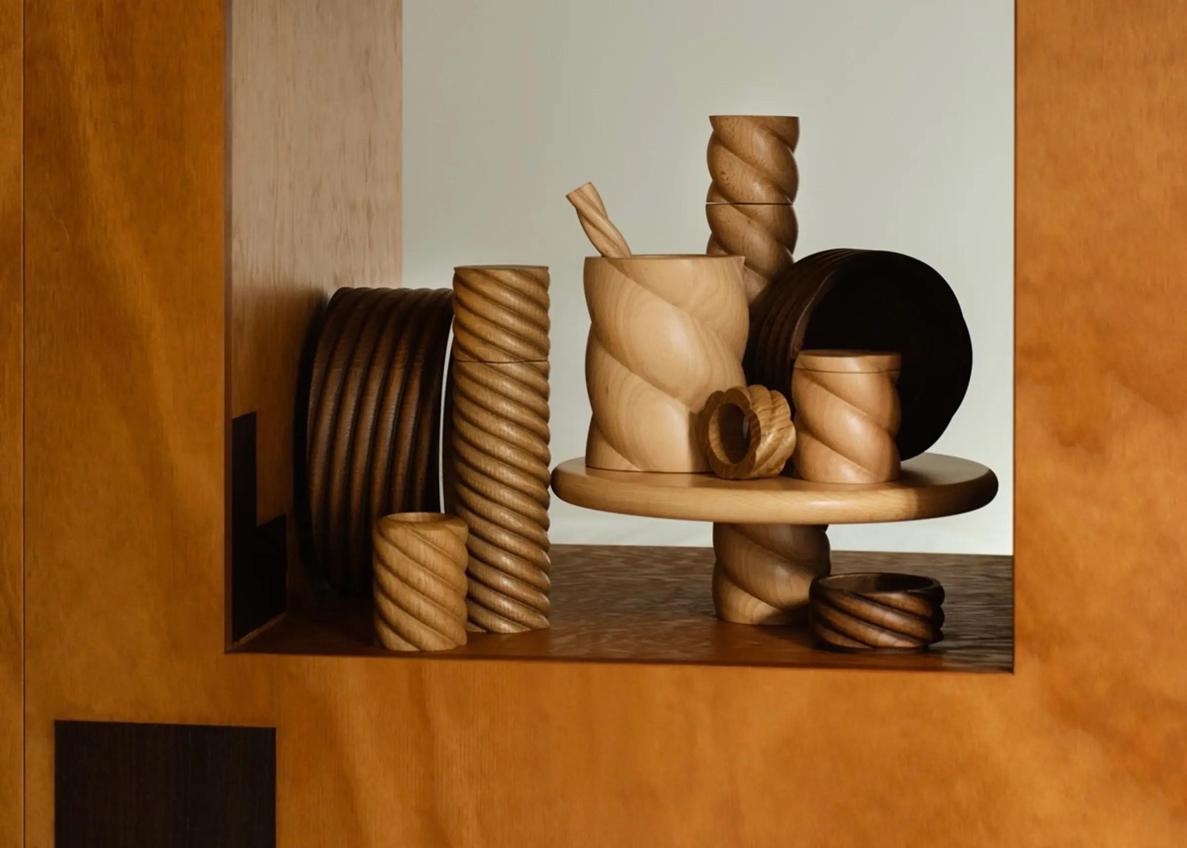 A collection of hand turned wooden pieces from Oros Design, all from the torsade collection featuring twists based off 17th century turned wood legs.