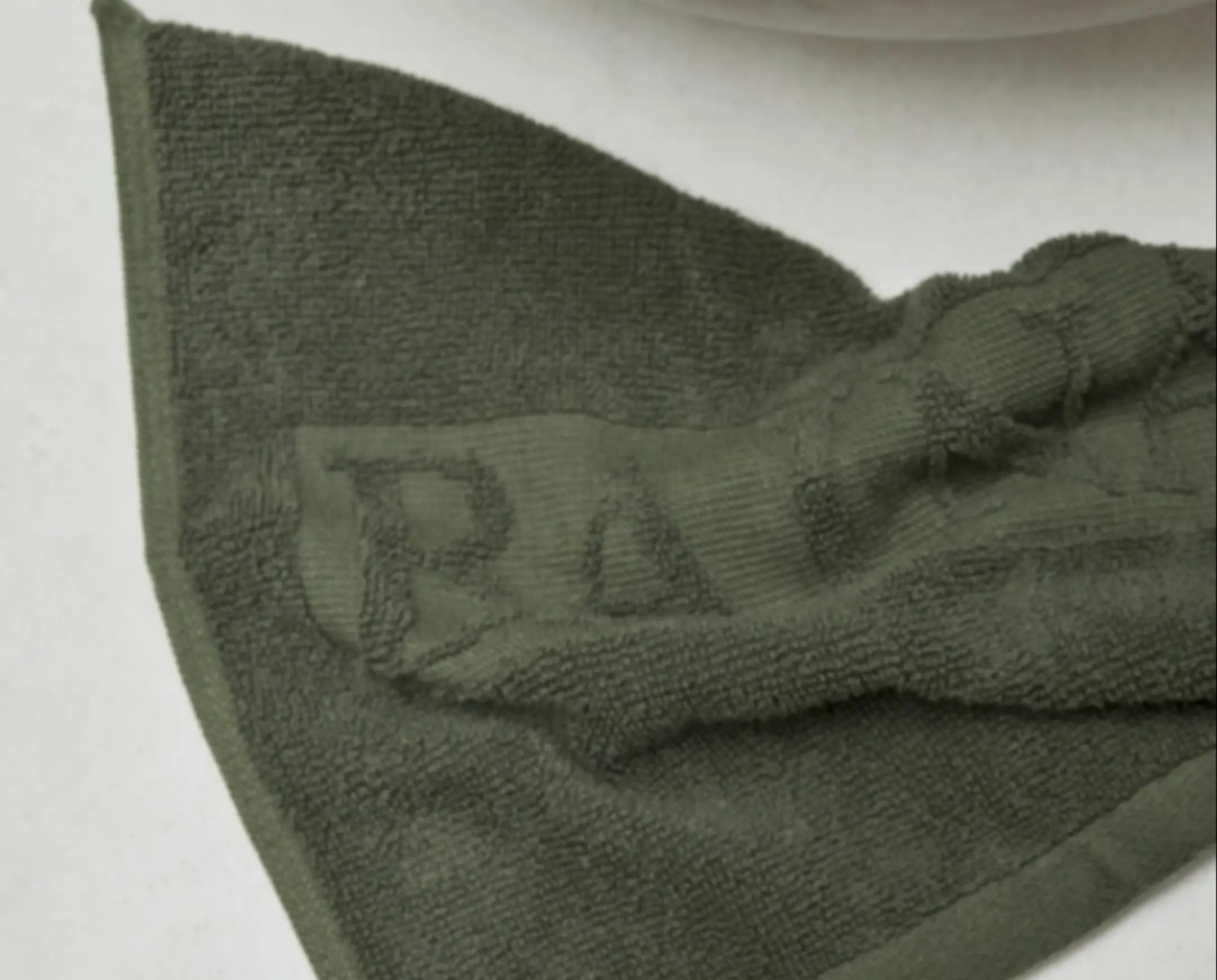 A scrunched face cloth on beside a sink
