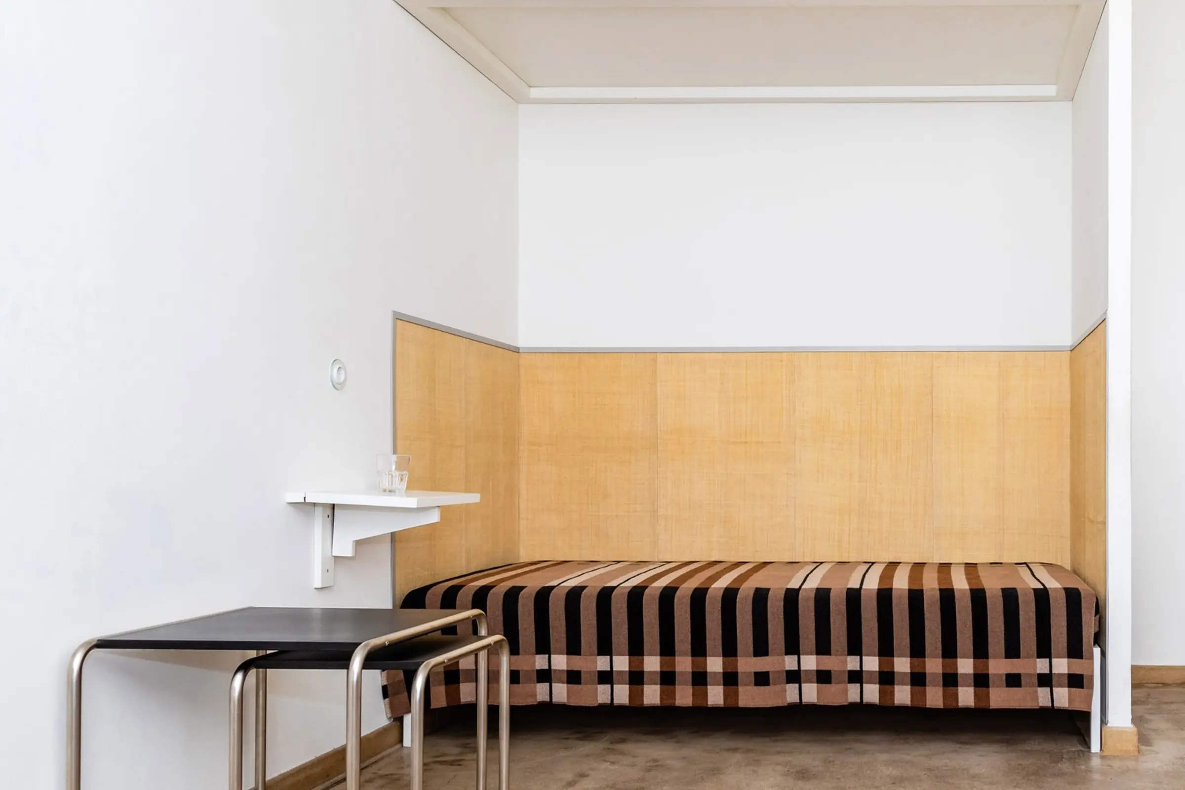 A Wallace Sewell Blanket in a Bauhaus dorm room setting.