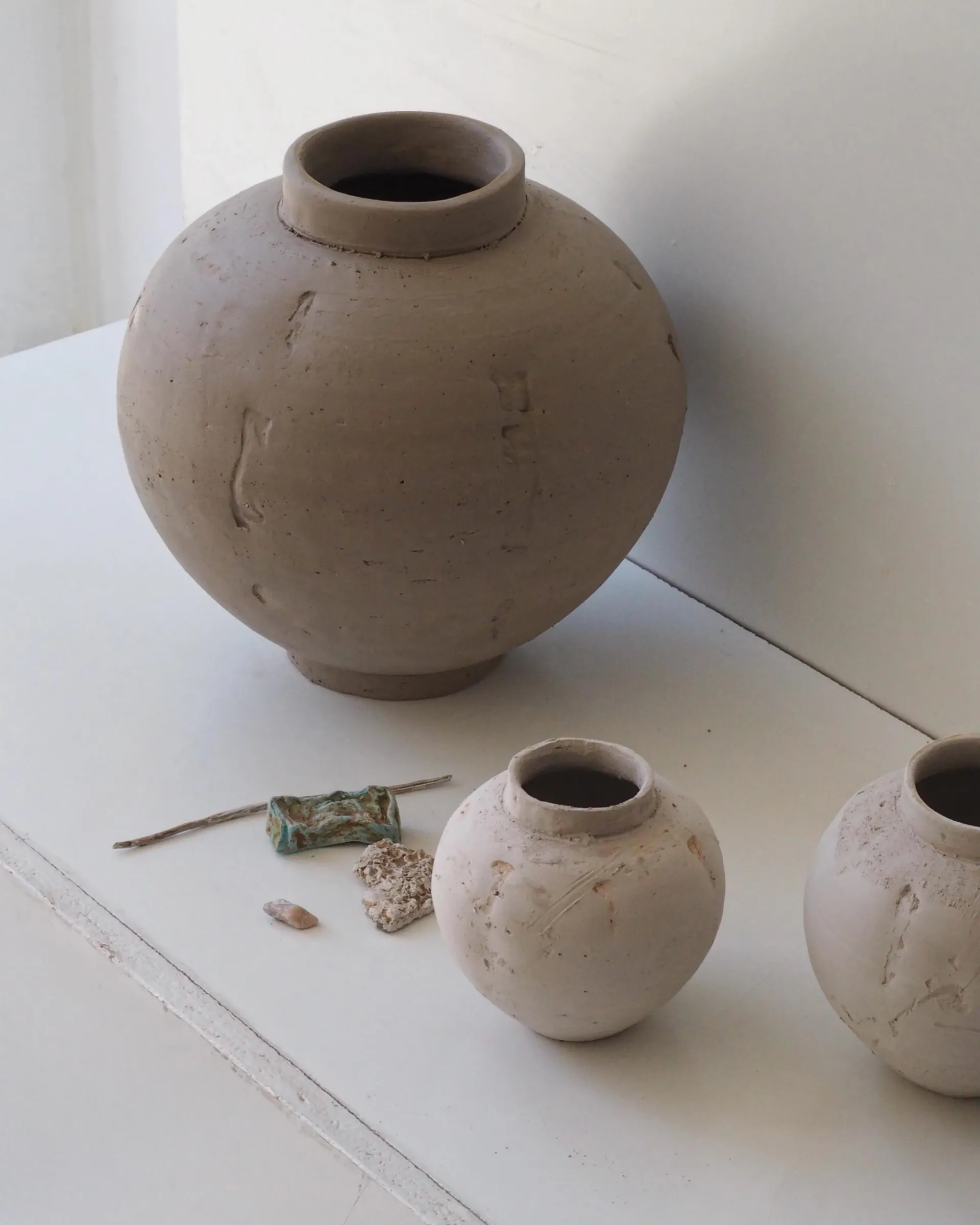 an image of ceramic vases sitting on a white shelf from Holly rose Morgans ceramic studio