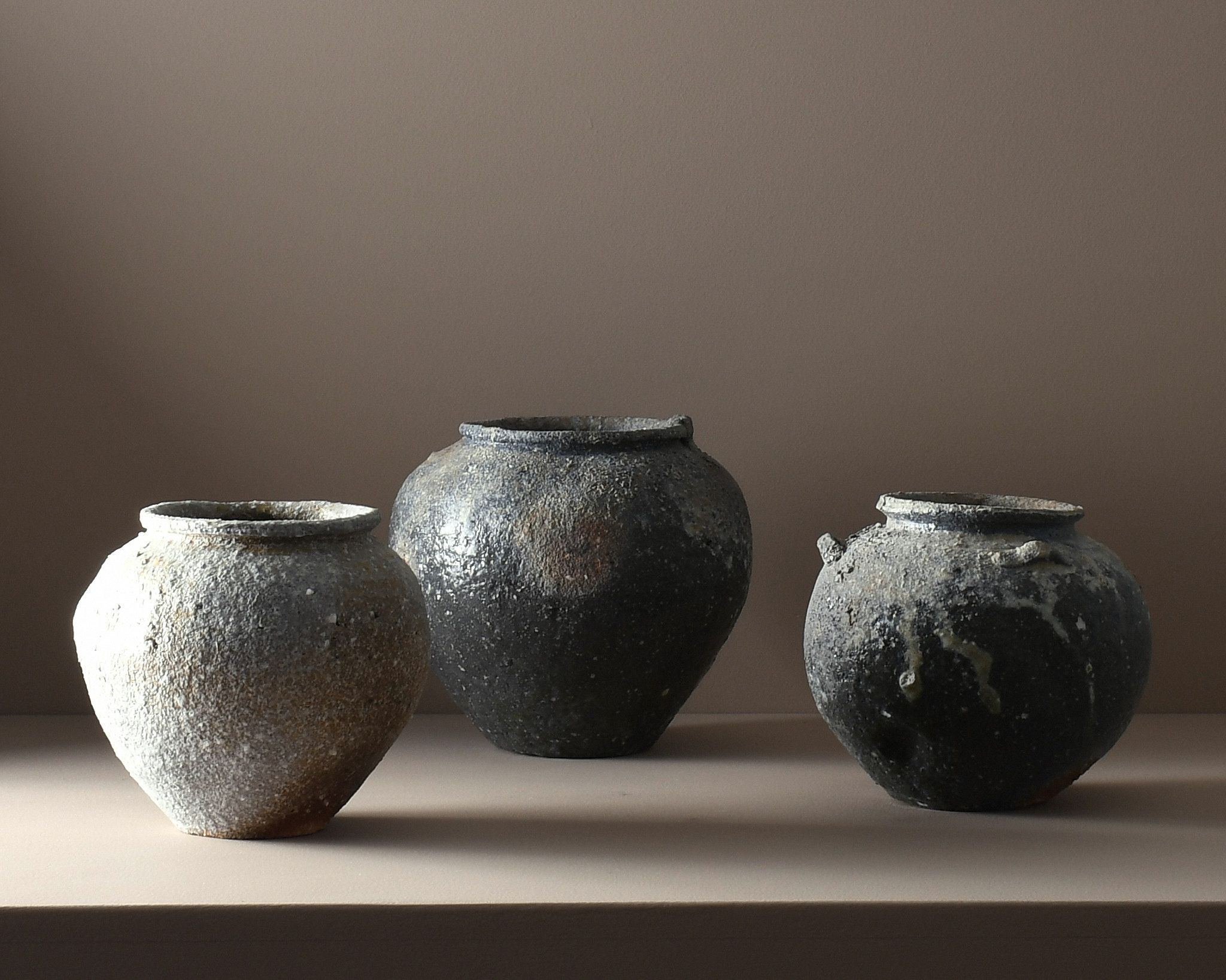 A trio of A one-of-a-kind stoneware vases by Aotearoa ceramic artist Holly Rose Morgan, made in Japan from Japanese Shigaraki clay before travelling to New Zealand to be wood-fired in the historic anagama kiln at Kamaka Pottery, Bridge Pā.