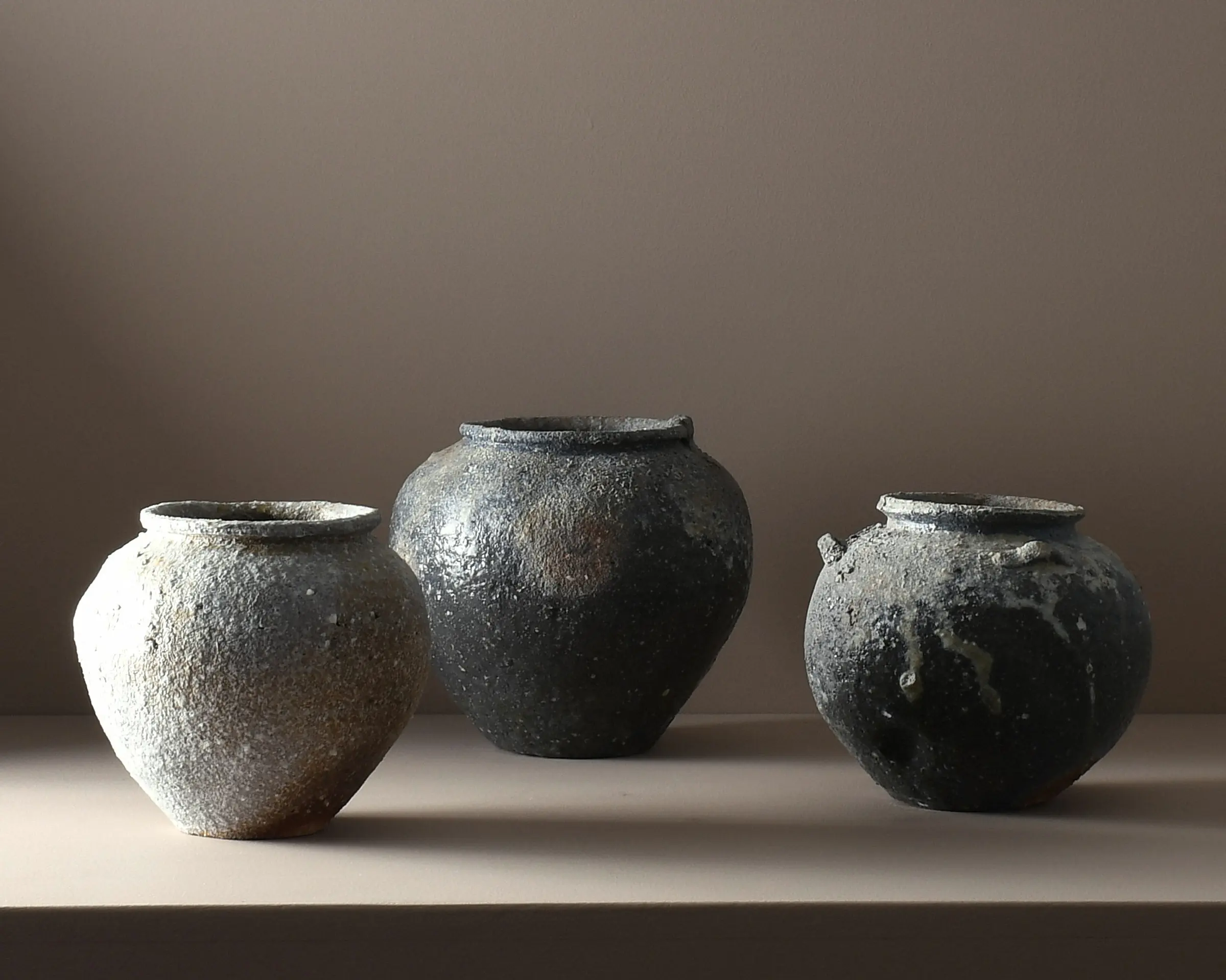 A trio of A one-of-a-kind stoneware vases by Aotearoa ceramic artist Holly Rose Morgan, made in Japan from Japanese Shigaraki clay before travelling to New Zealand to be wood-fired in the historic anagama kiln at Kamaka Pottery, Bridge Pā.