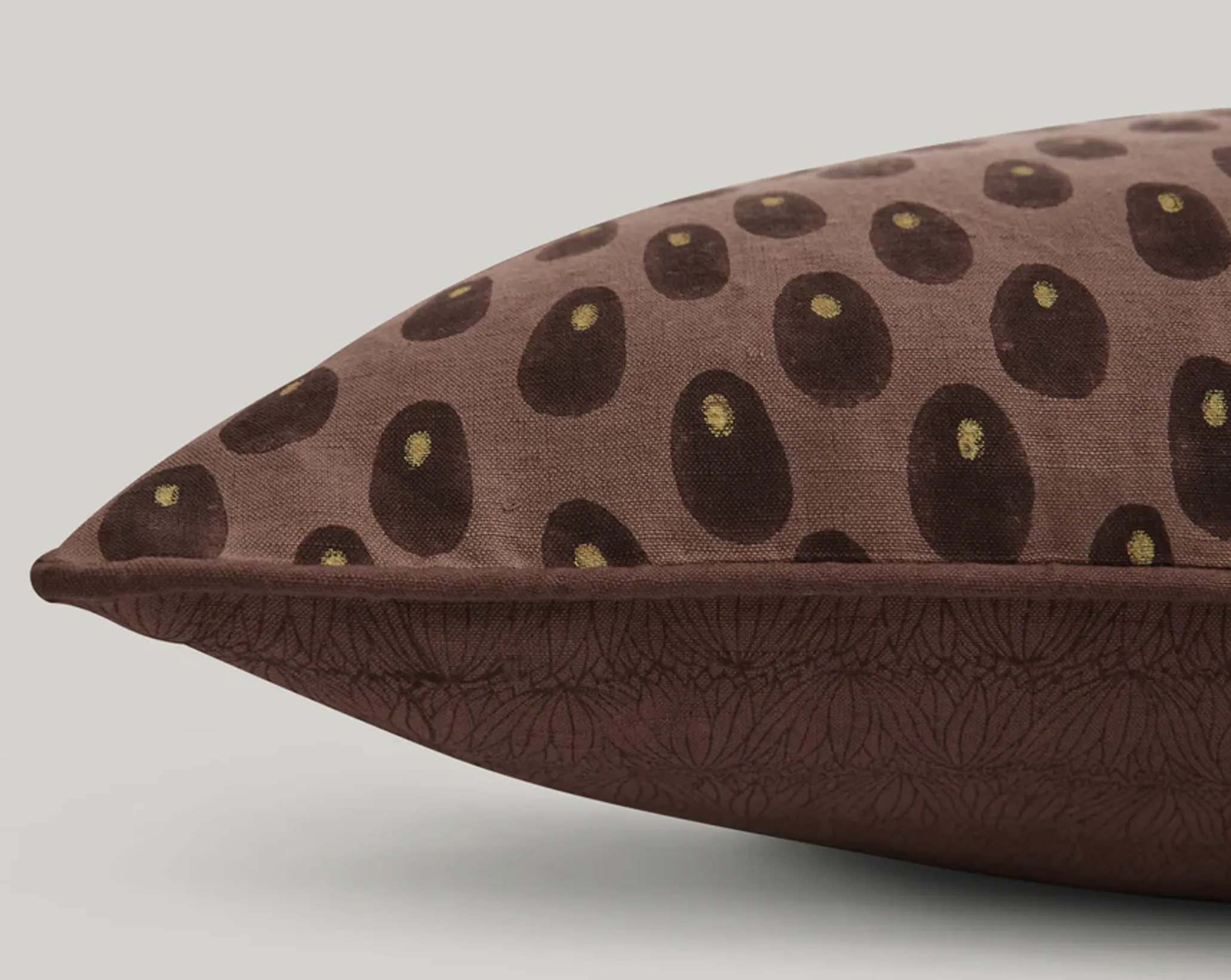 a close up of the print for Studio fords Sphinx lumbar cushions in brown tones