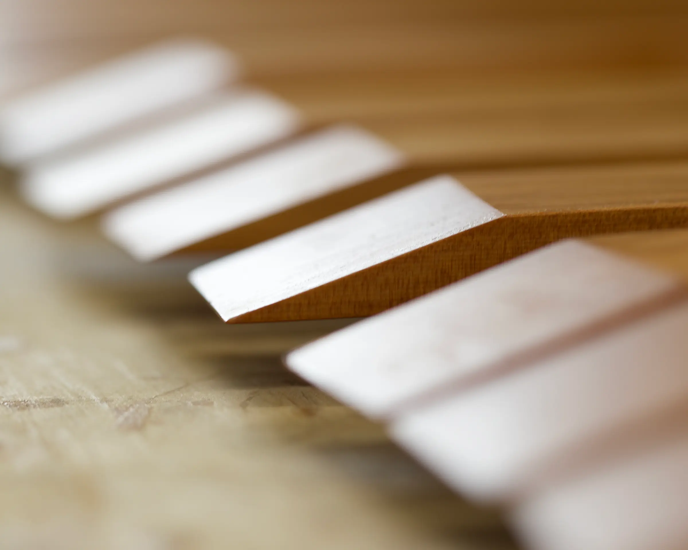 A close up detail of Courtney pelters mini spatula edge hand carved in New Zealand from matai wood